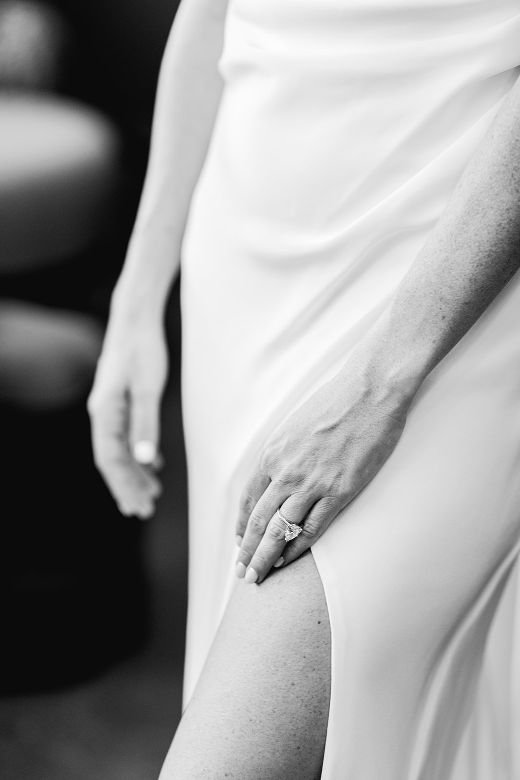Detail of bride's hand and engagement ring against gown at Mayfair House Hotel & Garden in Miami on wedding day.