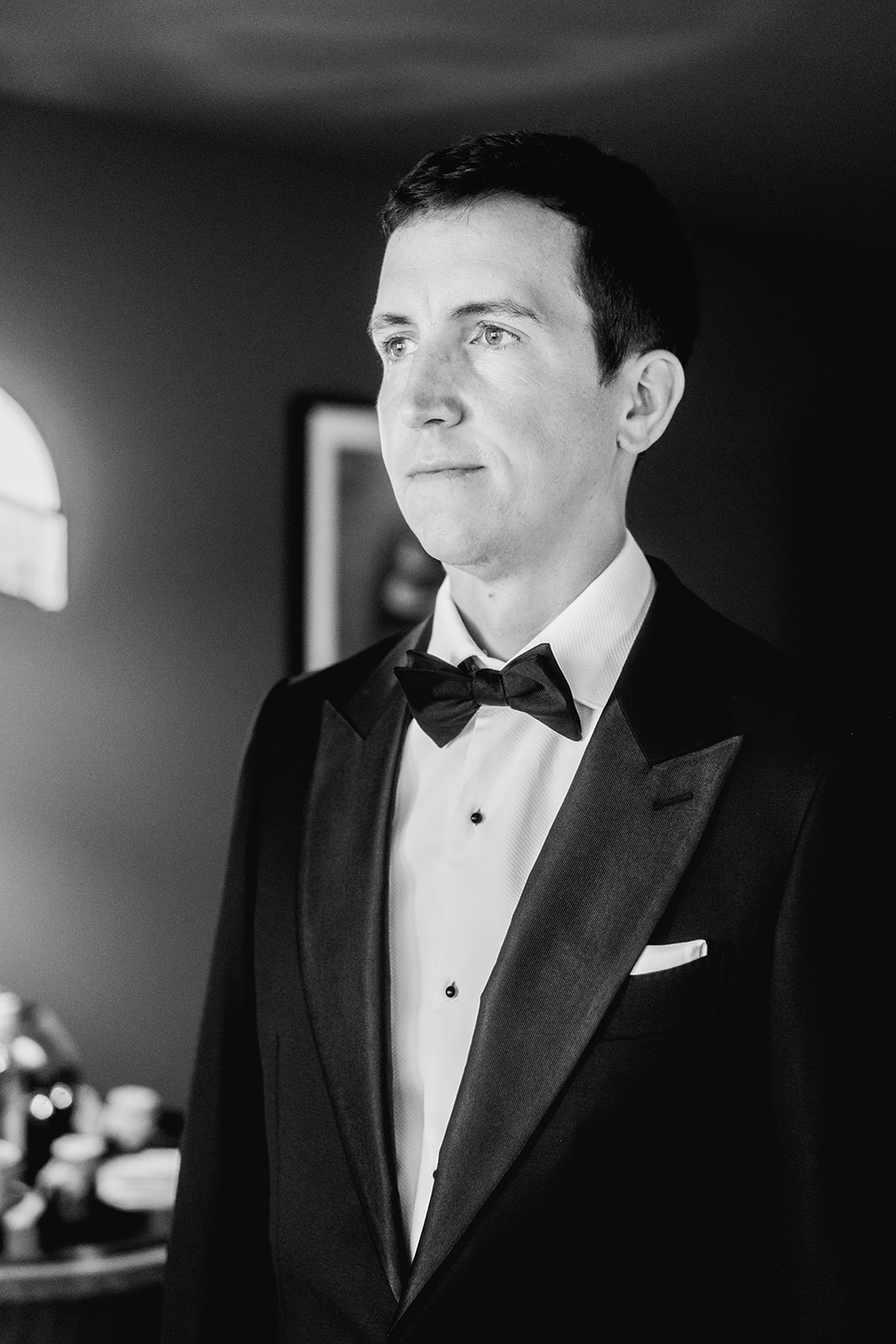Black and white groom portrait before ceremony at Mayfair House Hotel & Garden in Miami on wedding day.