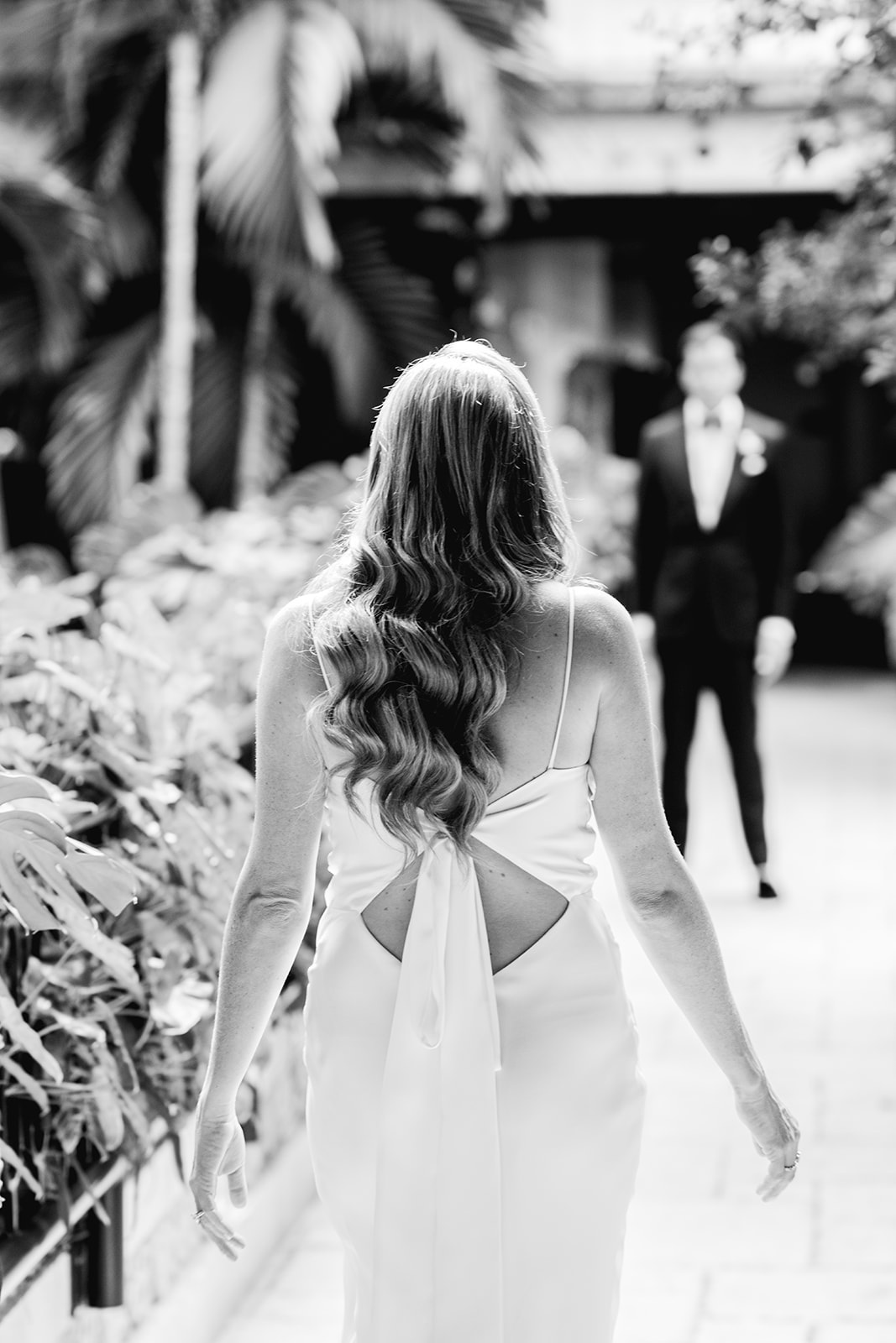 Black and white of bride and groom during first look at Mayfair House Hotel & Garden in Miami on wedding day.