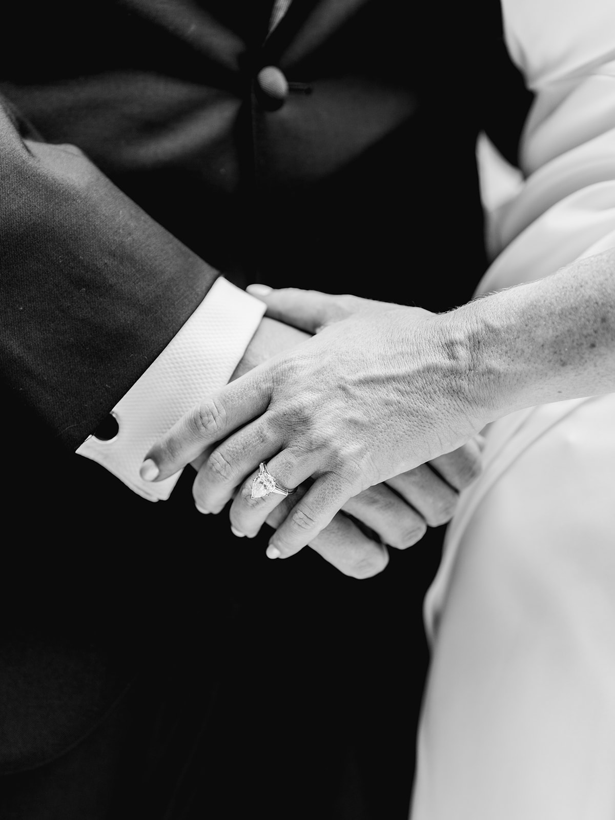 Black and white detail of bride & groom hands after first look at Mayfair House Hotel & Garden in Miami on wedding day.