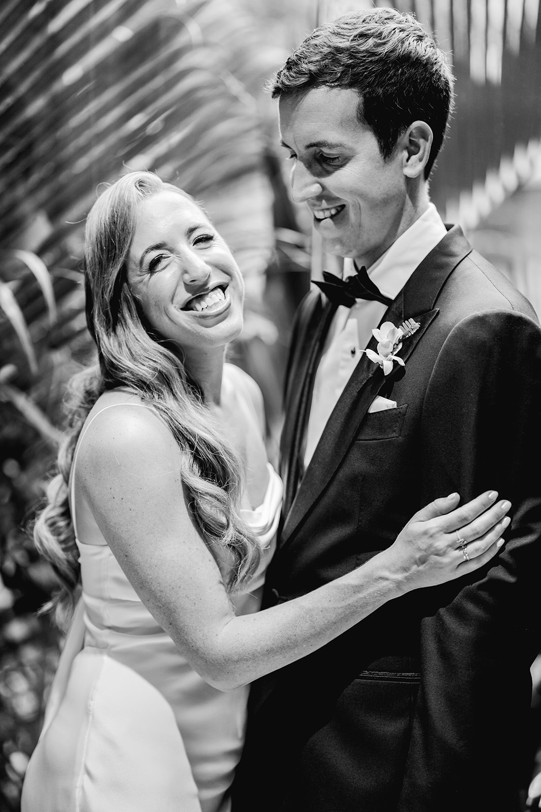 Black and white bride & groom laughing in elevator at Mayfair House Hotel & Garden in Miami on wedding day.