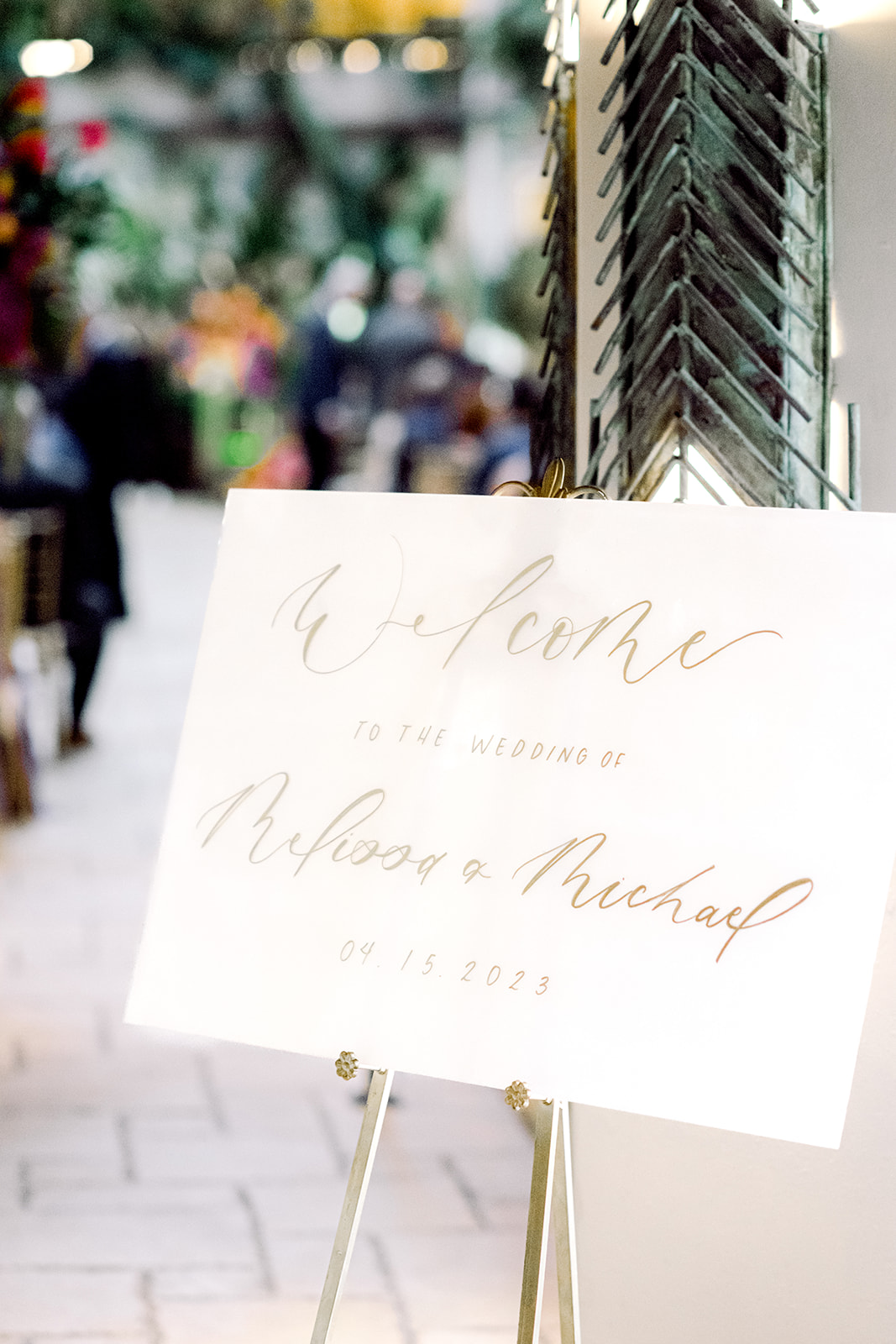 Welcome sign at ceremony site at Mayfair House Hotel & Garden in Miami on wedding day.