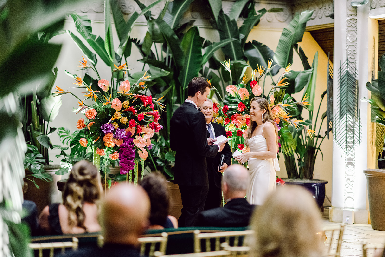 Groom reads handwritten vows at ceremony at Mayfair House Hotel & Garden in Miami on wedding day.