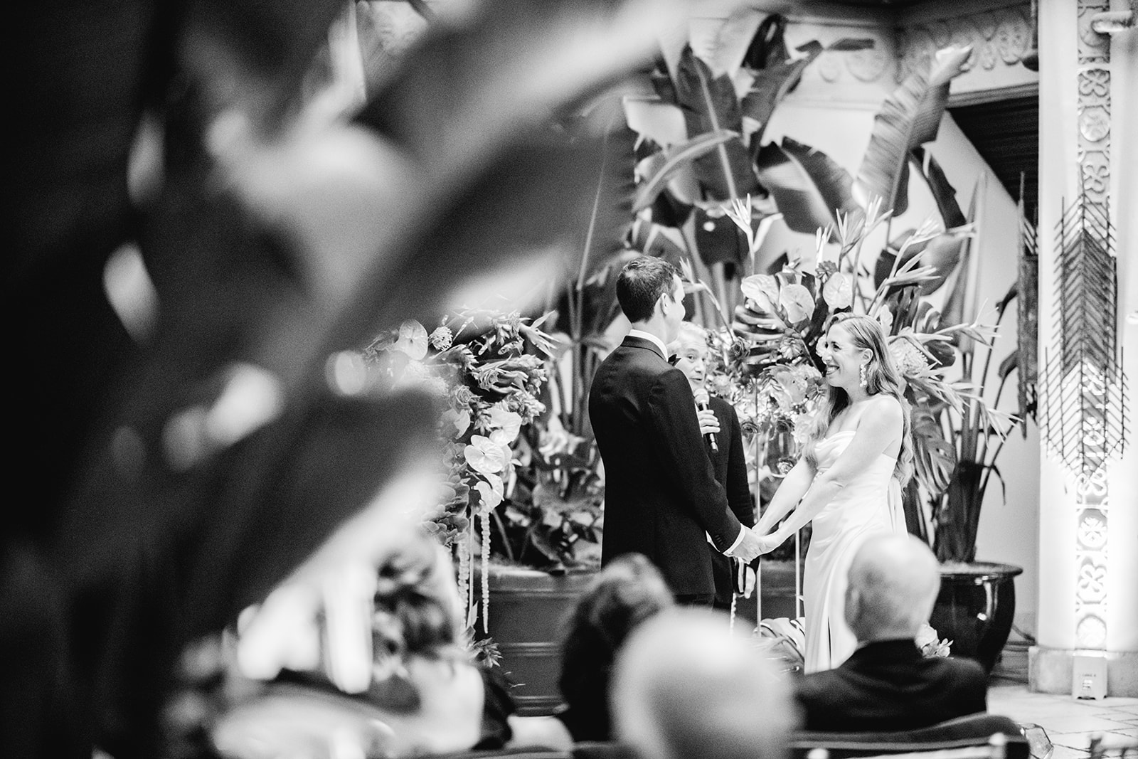 Black and white of bride and groom smiling after ring exchange at Mayfair House Hotel & Garden in Miami on wedding day.