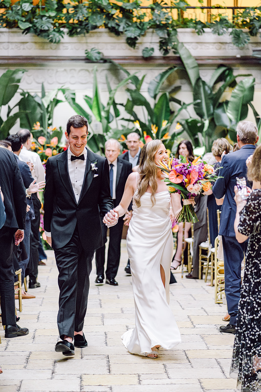 Bride and groom recessional at ceremony at Mayfair House Hotel & Garden in Miami on wedding day.