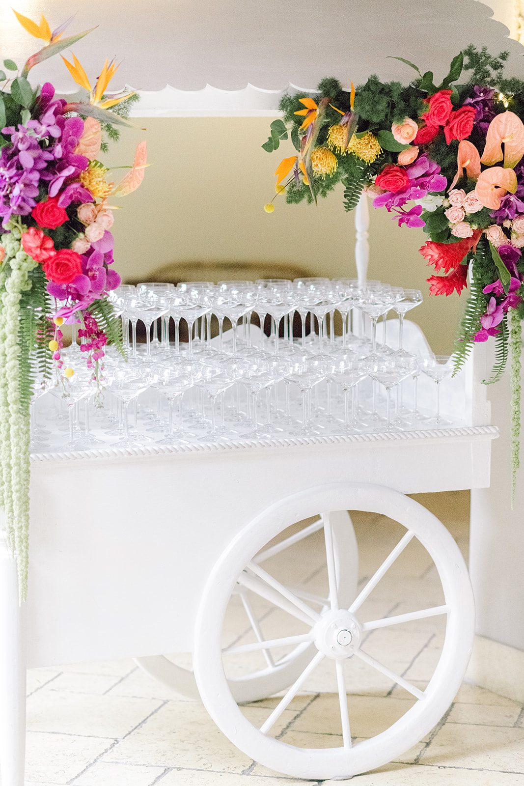Champagne cart covered in flowers at cocktail hour at Mayfair House Hotel & Garden in Miami on wedding day.