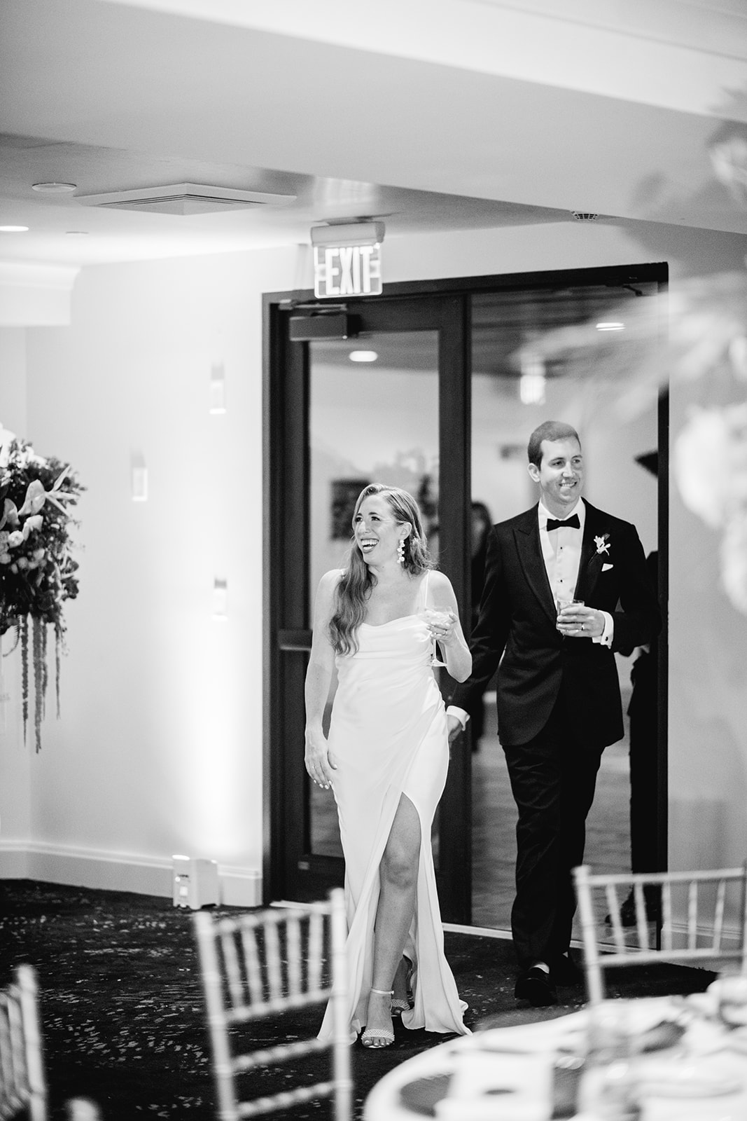 Black and white of bride and groom reaction of reception decor at Mayfair House Hotel & Garden in Miami on wedding day.
