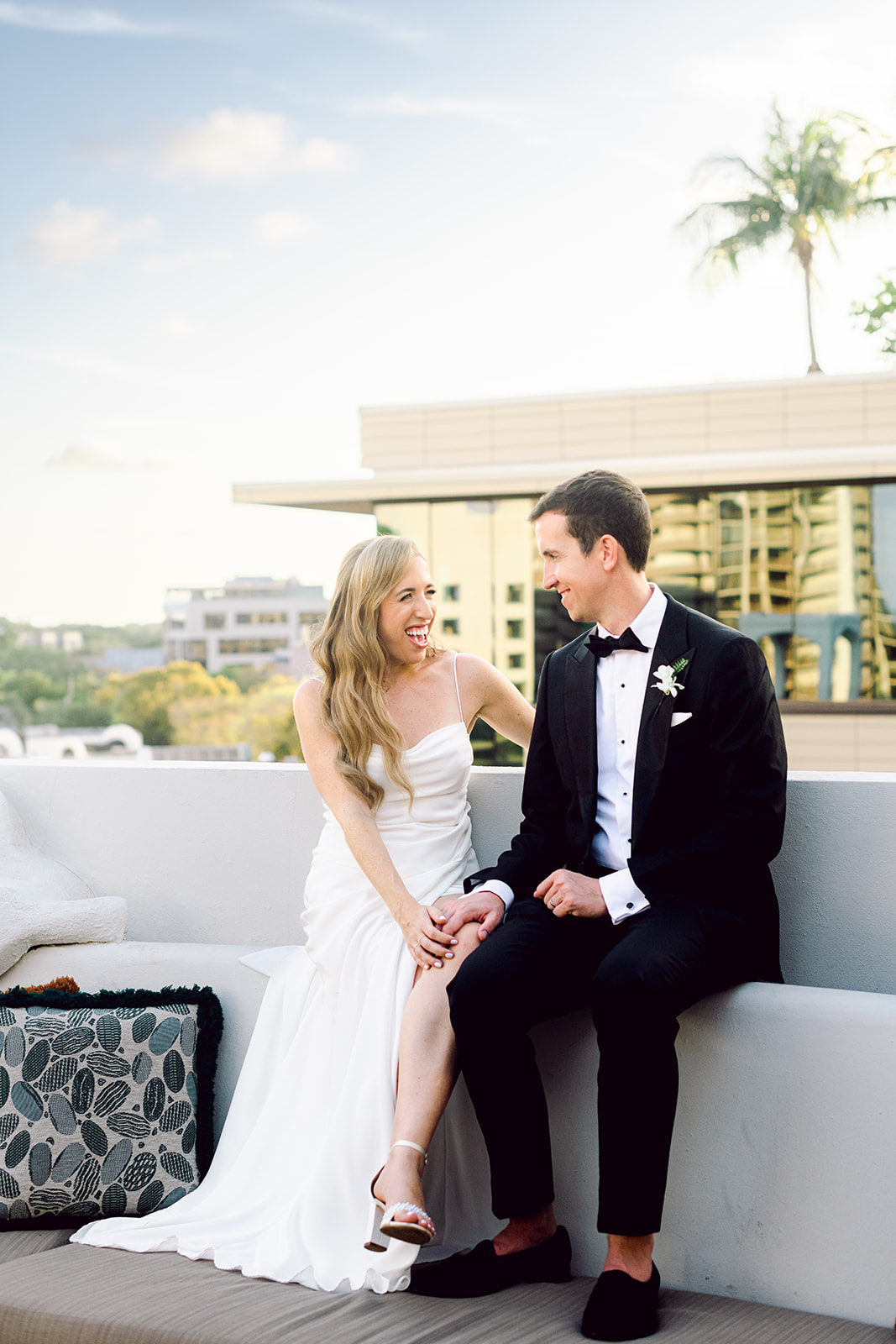 Newlywed golden hour portrait session couple smiling at Mayfair House Hotel & Garden in Miami on wedding day.