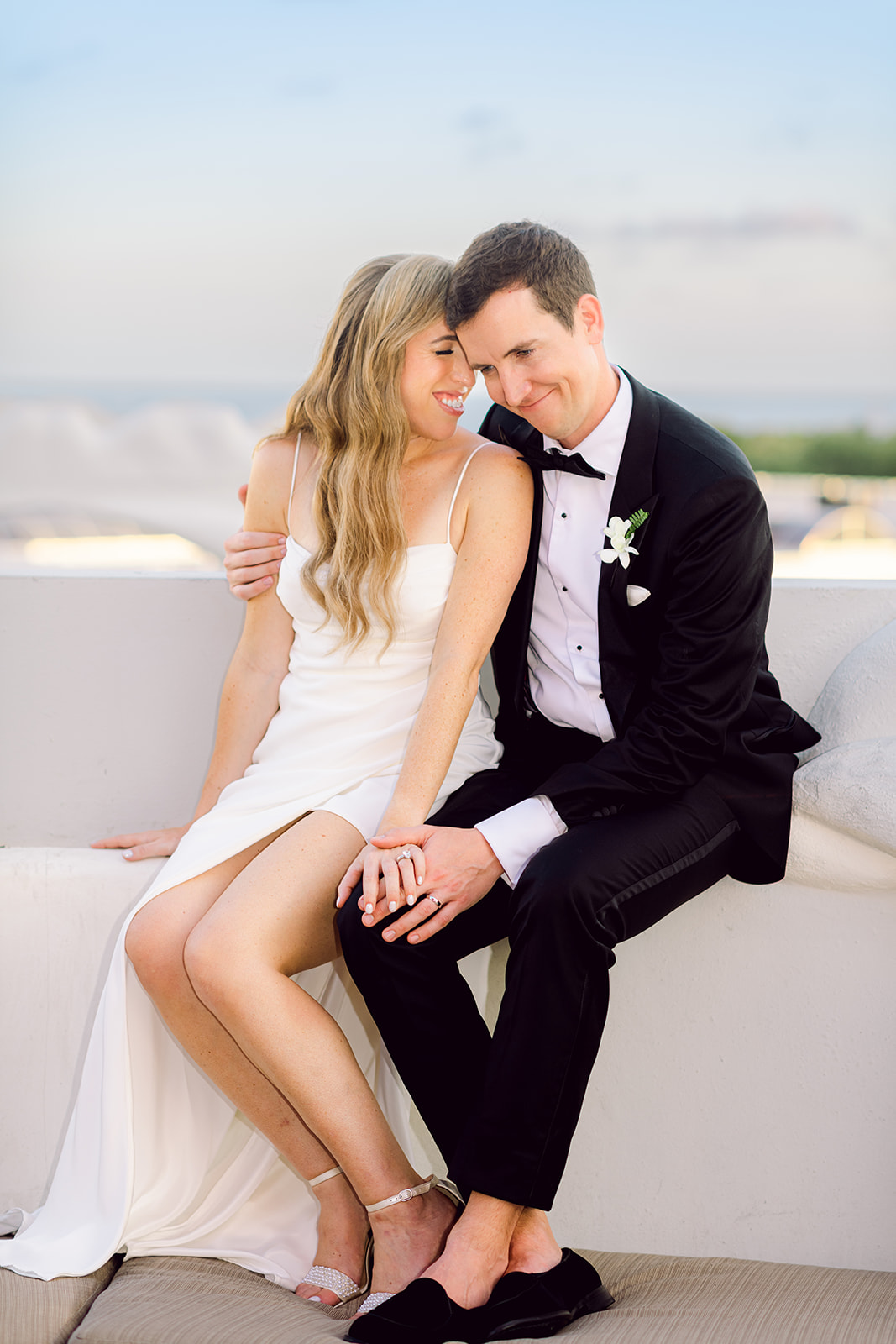 Newlywed golden hour rooftop portrait session couple cuddling at Mayfair House Hotel & Garden in Miami on wedding day.