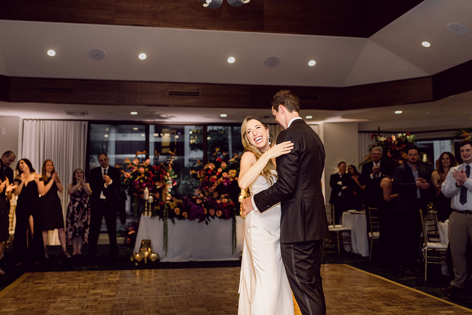 Laughing bride and groom first dance at reception at Mayfair House Hotel & Garden, Miami on wedding day.