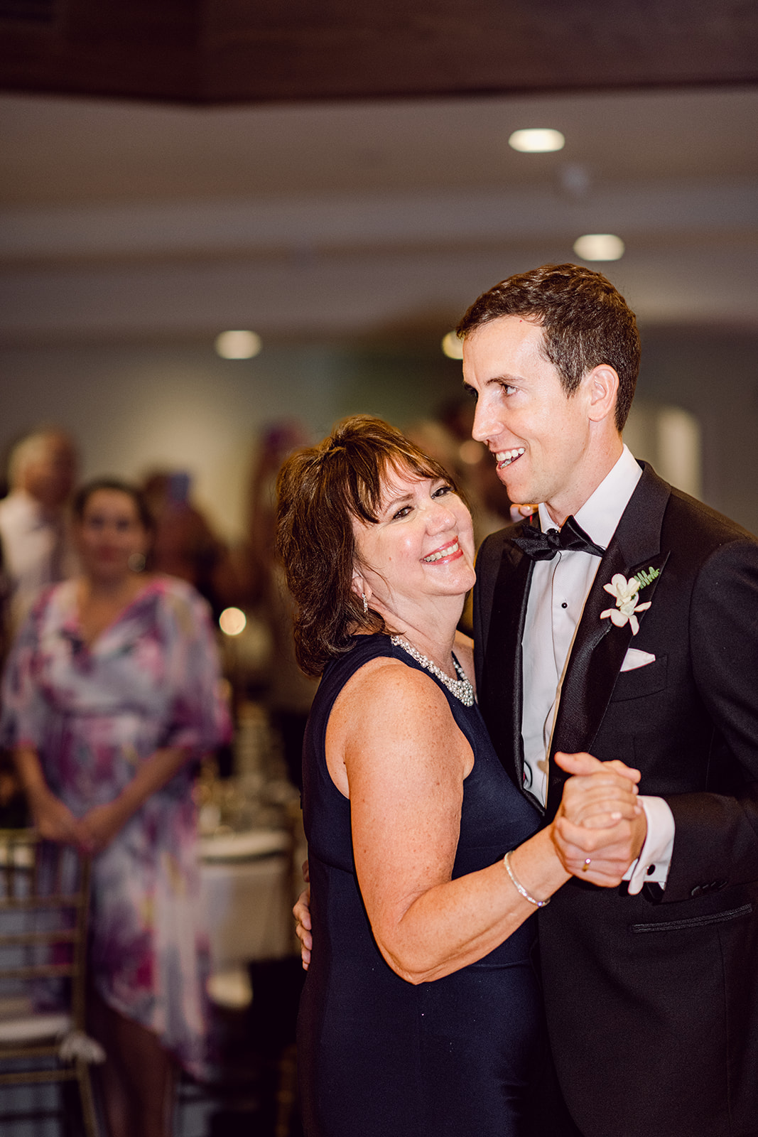 Mother son dance at reception at Mayfair House Hotel & Garden in Miami on wedding day.