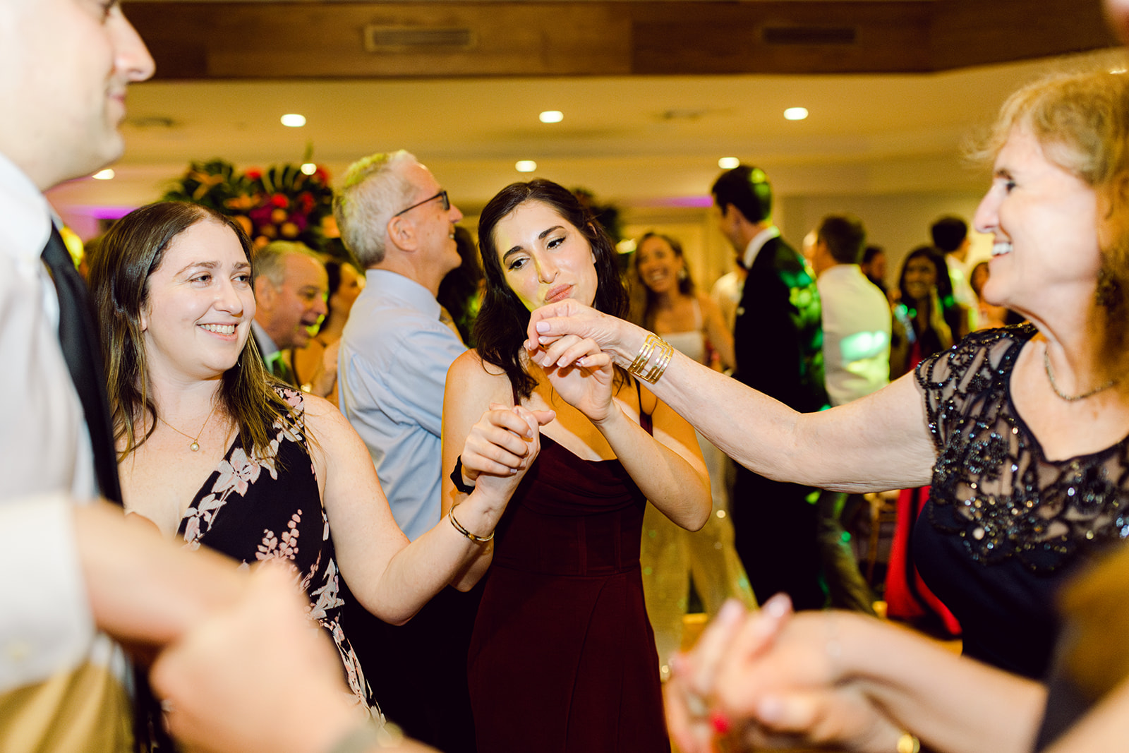 Candid of guests dancing in reception hall of Mayfair House Hotel & Garden, Miami on wedding day.