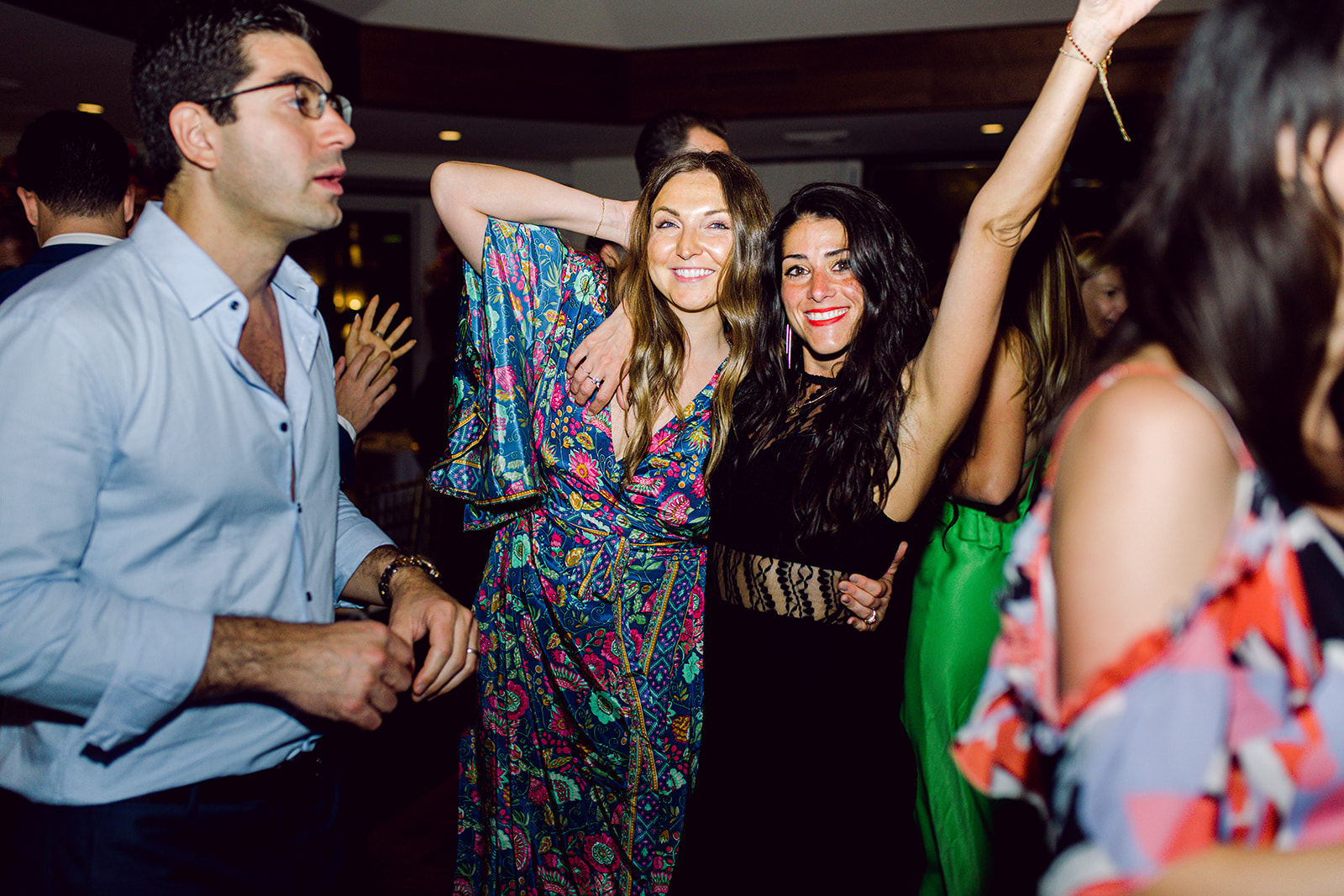 Guests stop dancing to posing on dance floor at wedding reception of Mayfair House Hotel & Garden, Miami.
