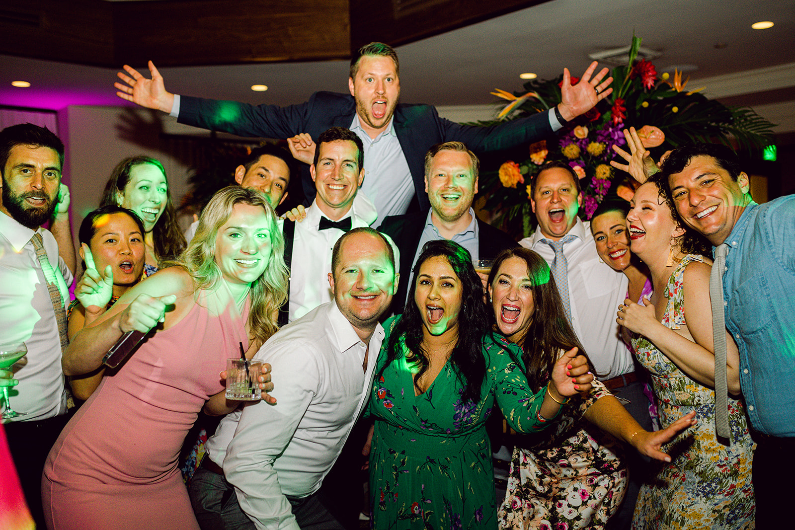 Groom with friends and colleagues pose on dance floor at wedding reception of Mayfair House Hotel & Garden, Miami.