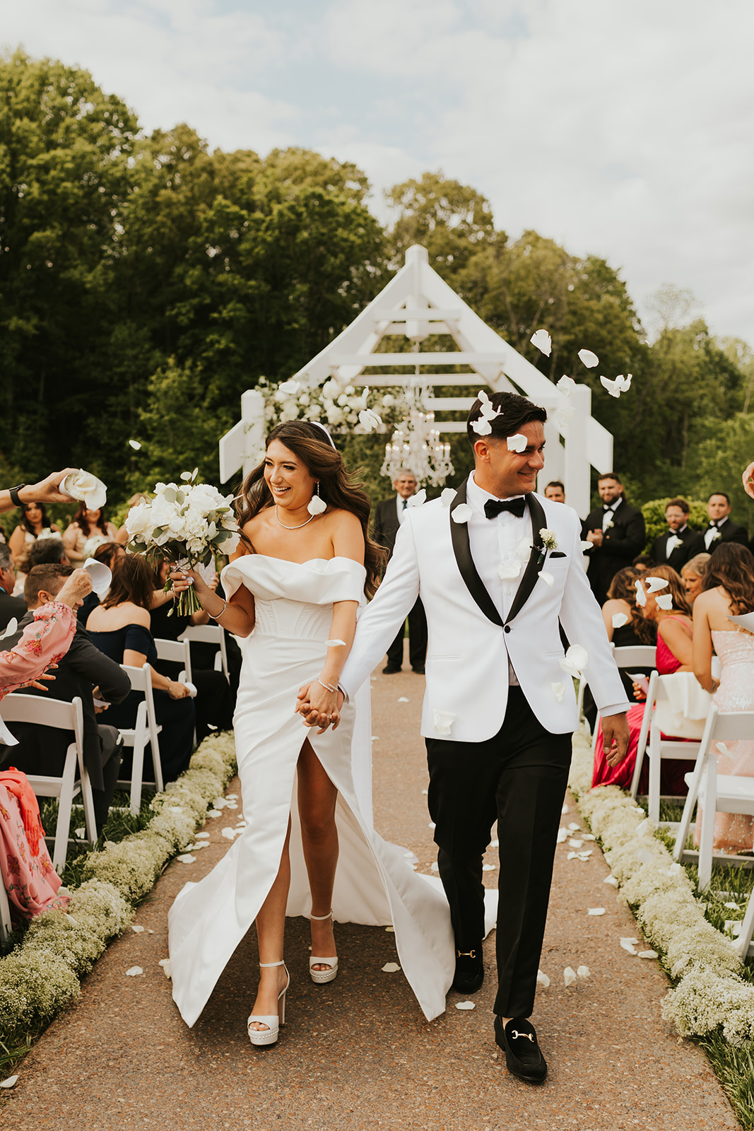 Bride and Groom celebrate as they walk down the aisle after saying "I do"