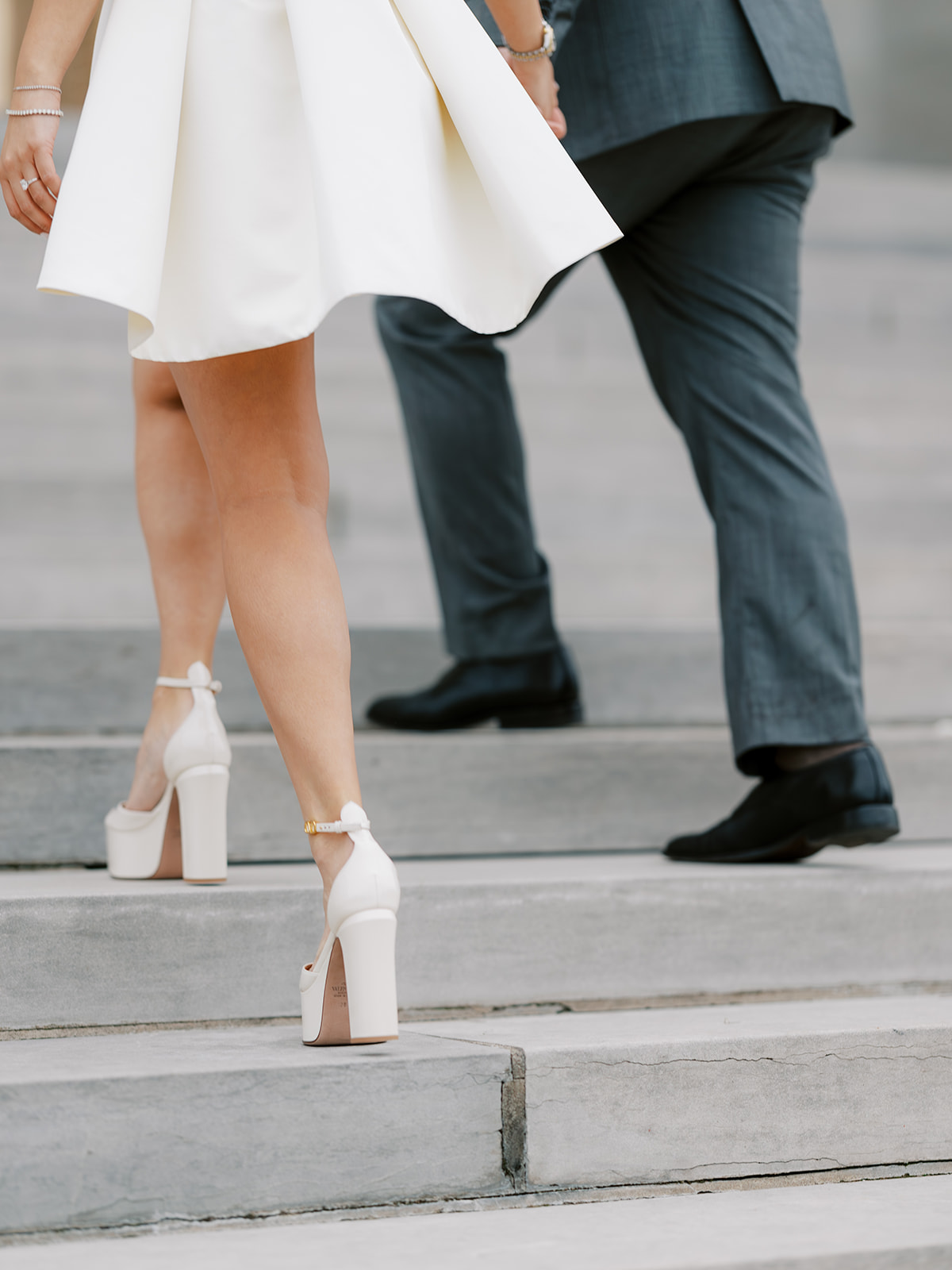 Closeup of couple's shoes as they walk up the steps of the Capitol