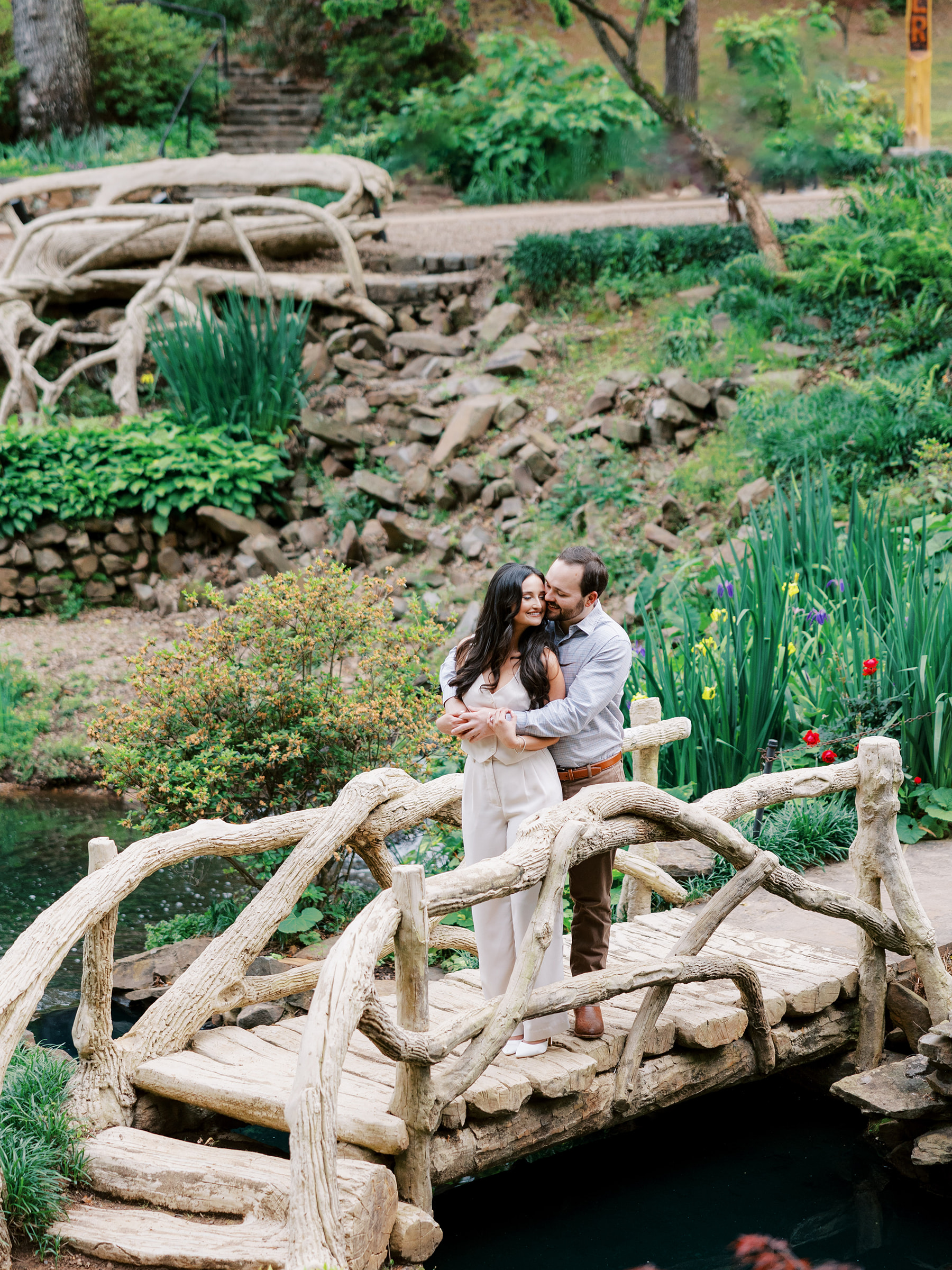 Couple stand on bridge together at Old Mill in Little Rock, Arkansas
