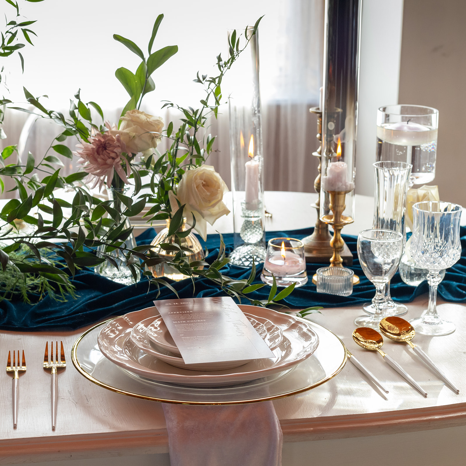 The decorated table with the place setting and dishware for the wedding.
