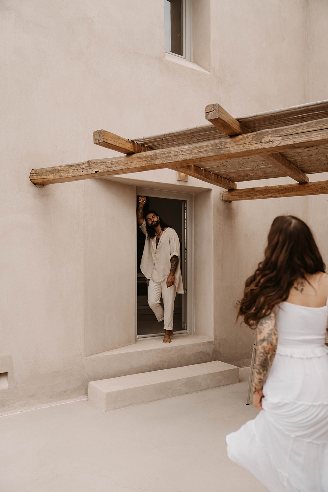 A couple getting ready together before their elopement in Santorini Greece