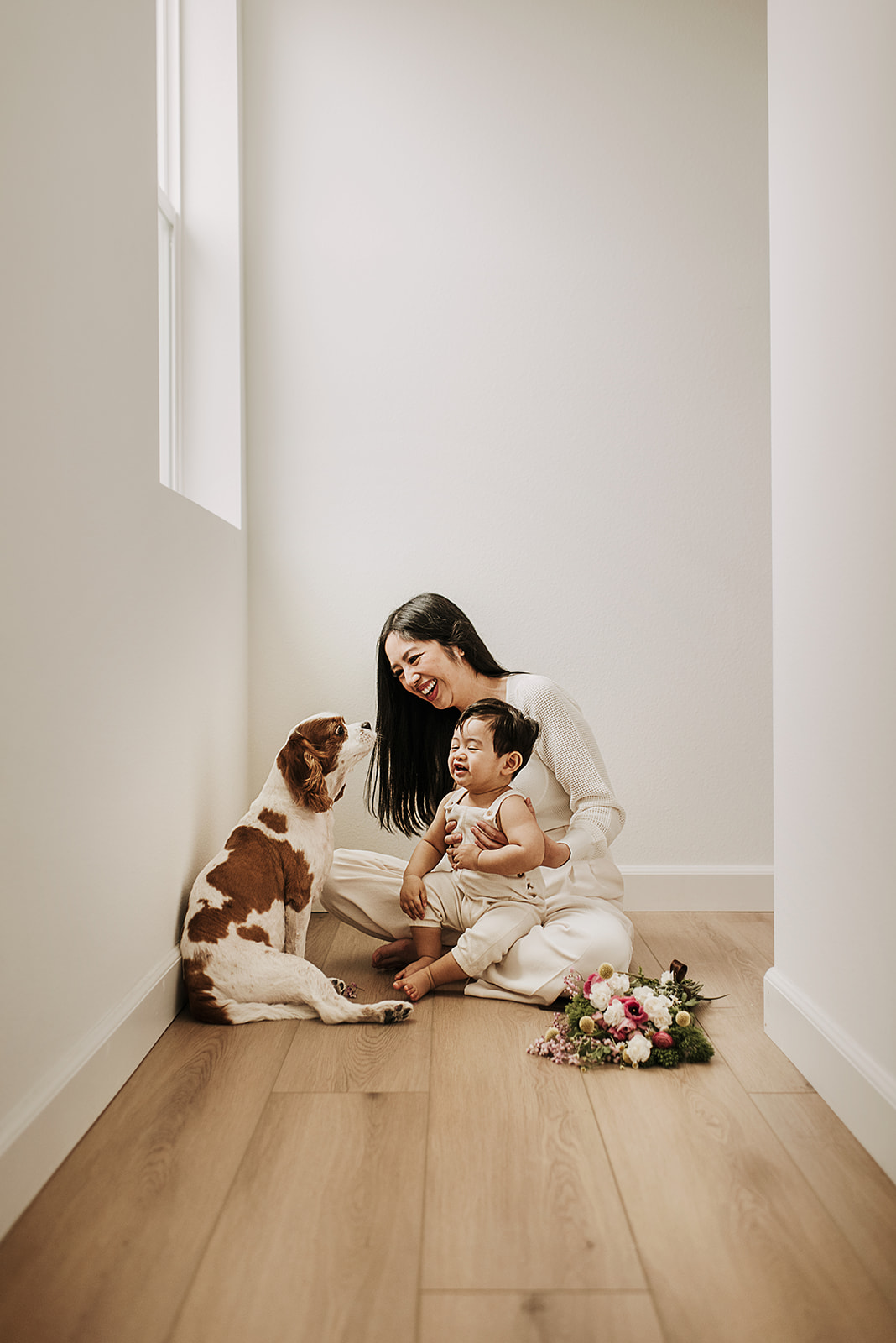 Mom, baby and their king charles during a photoshoot in 3 Roots home in Sorrento Mesa