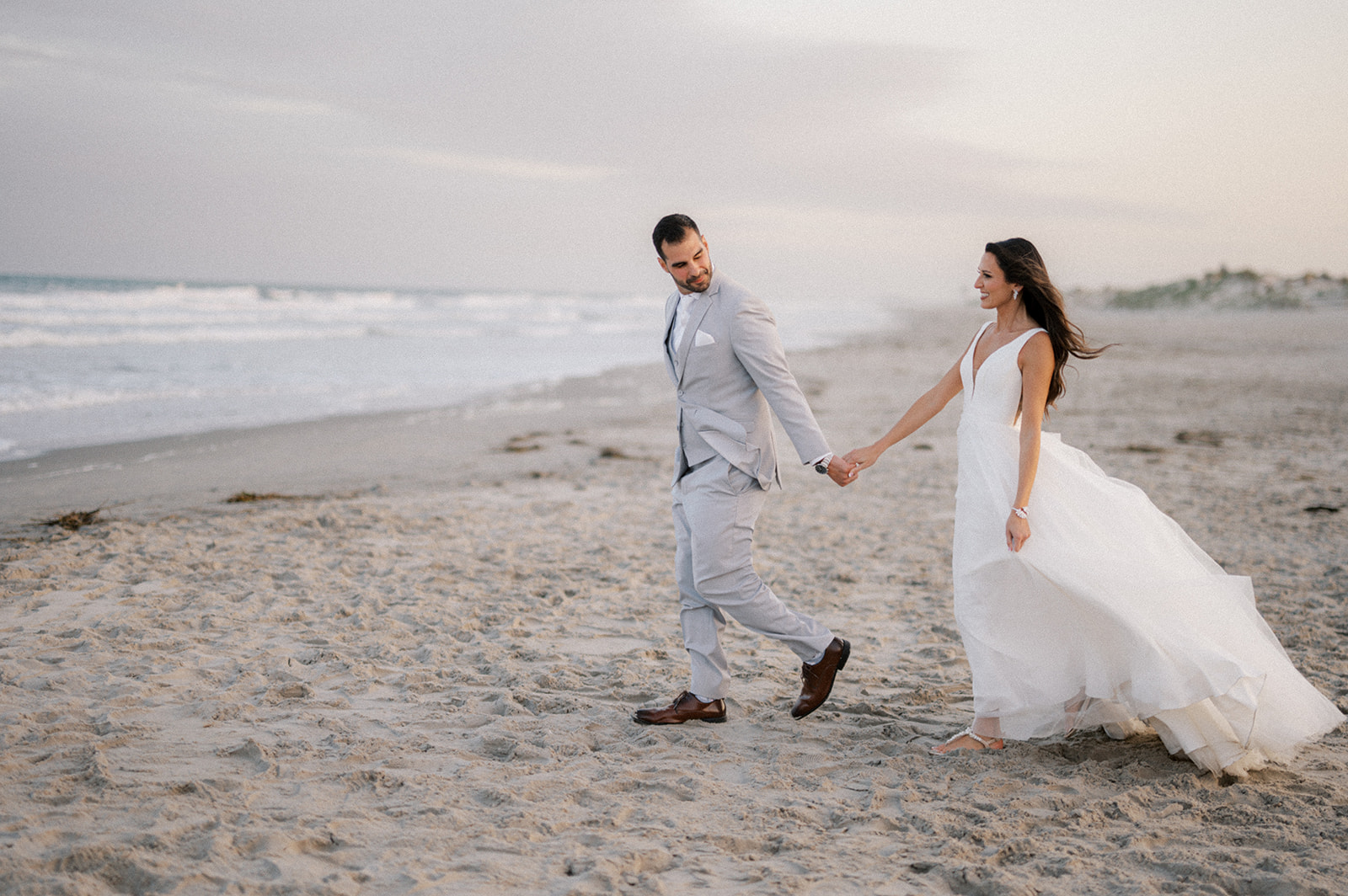 Bride and groom beach sunset portraits at Icona Avalon Wedding