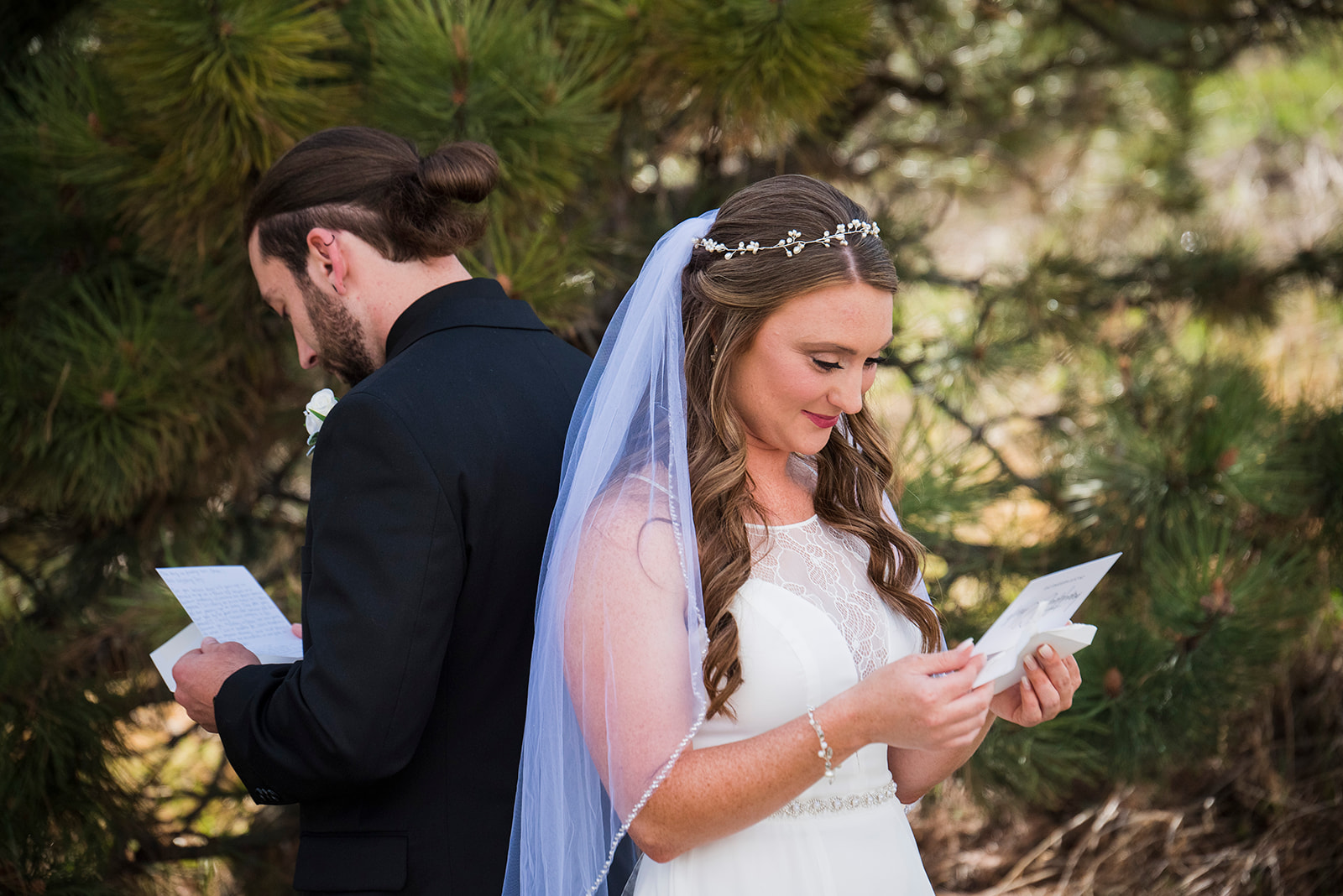 Bride and groom stand back to back and read letters to each other before seeing each other on their wedding day.