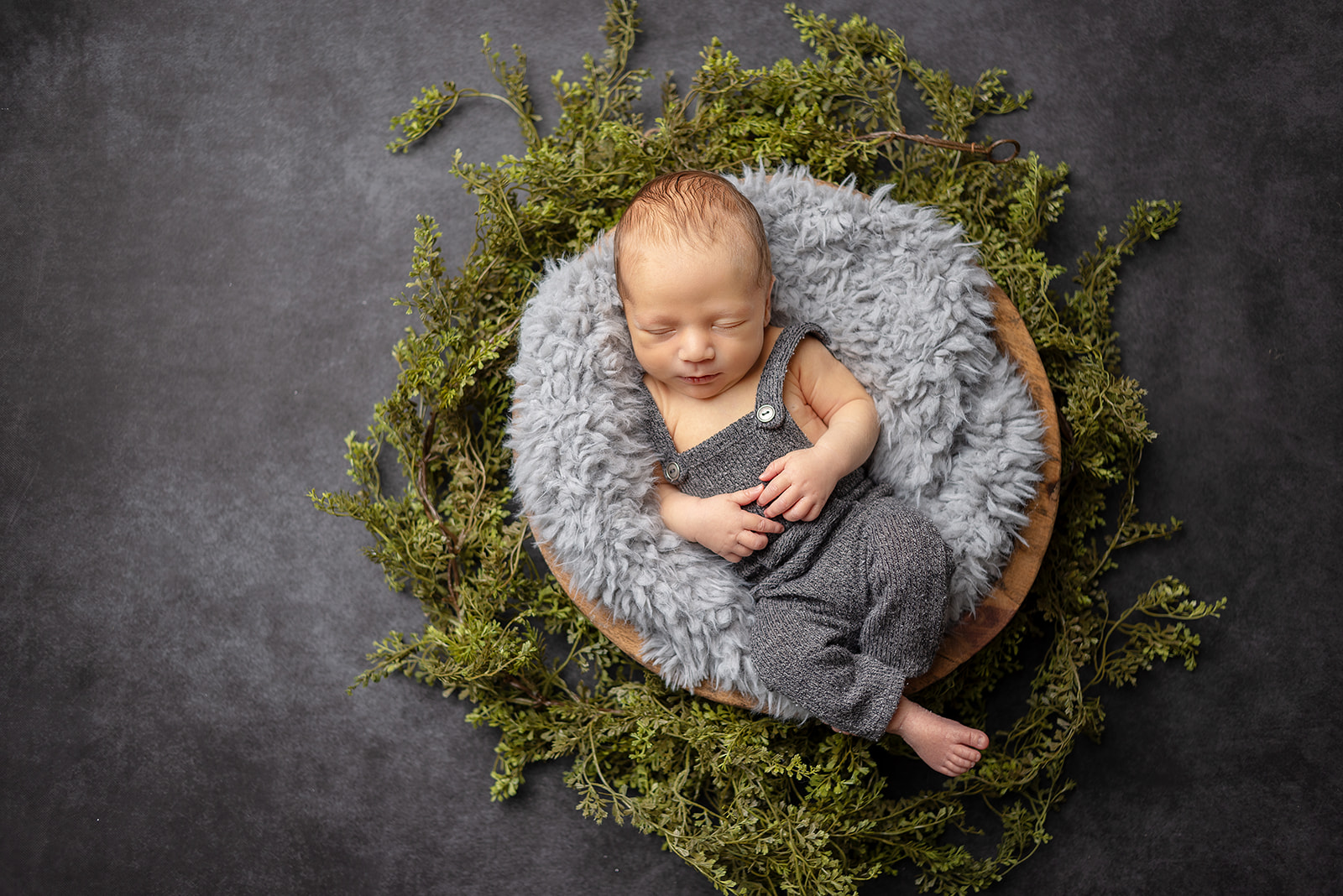A cozy sleeping baby at Celesta Champagne Photography studio located in Carthage, Missouri