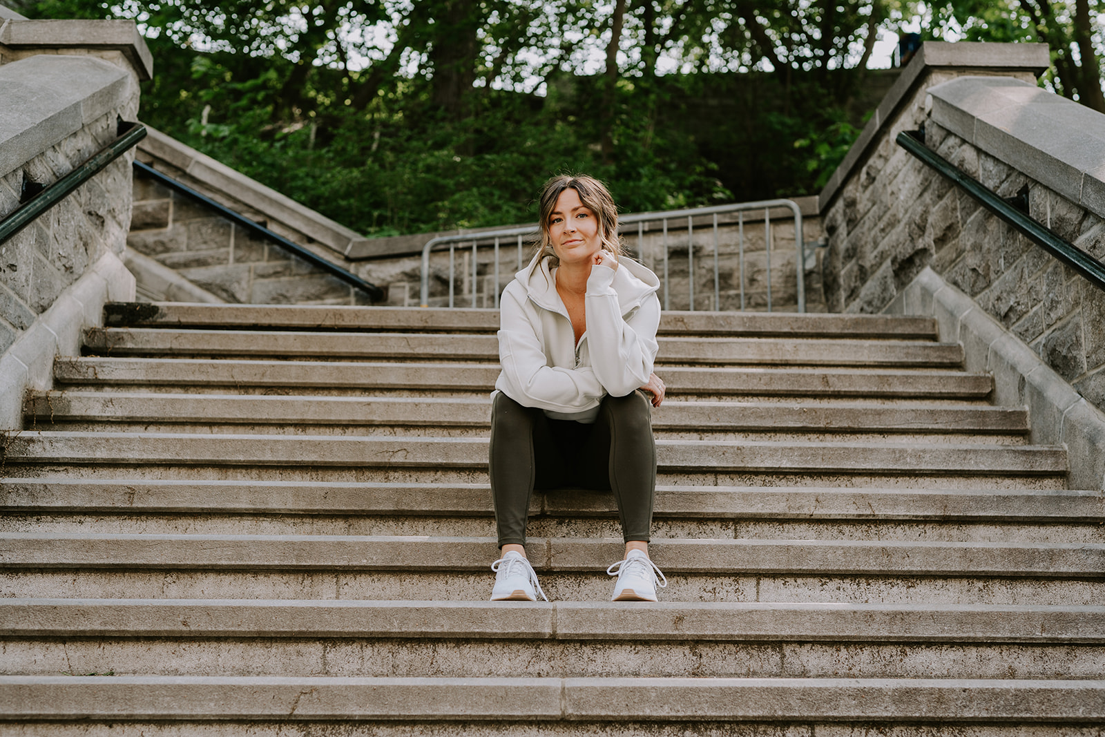 athletic woman sitting on concrete staircase