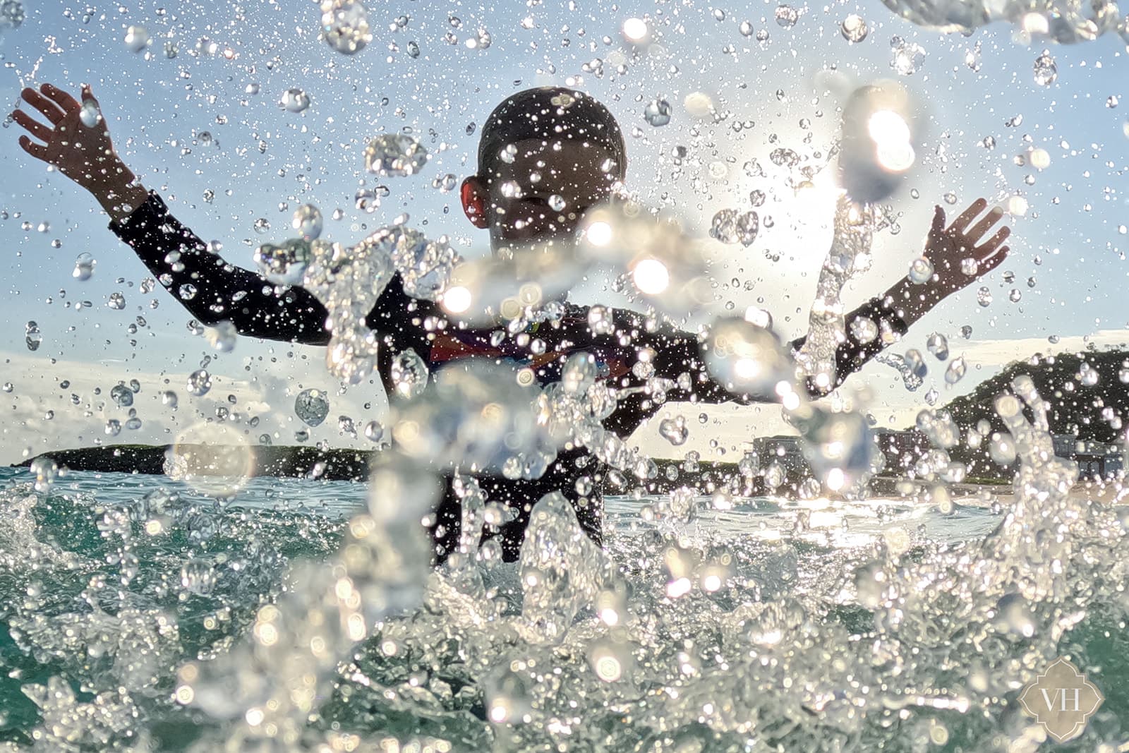 boy splashing in the waves at halfmoon bay beach 