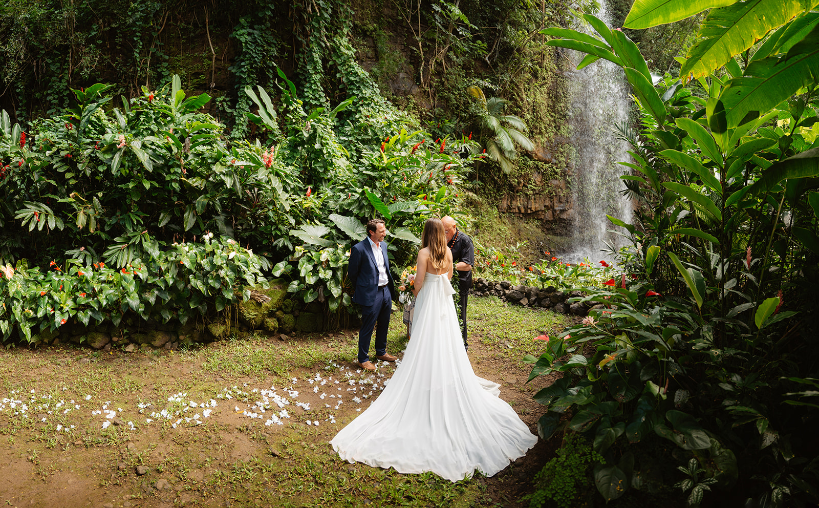A couple elopes at a secluded waterfall in Kauai, Hawaii