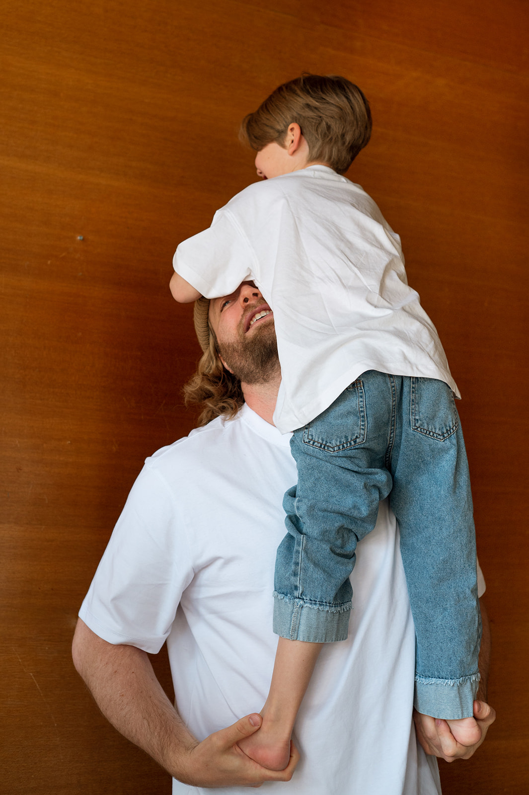 father and son playing in family portrait session at home in provo utah