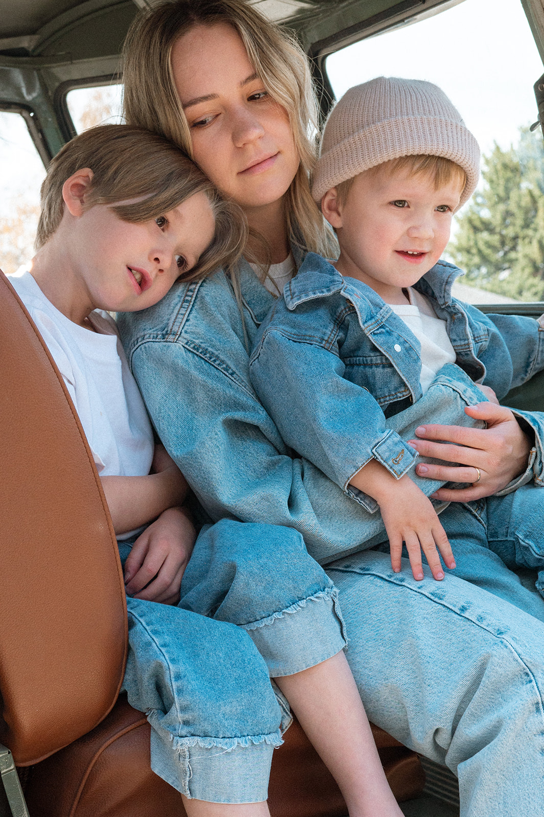 mother and sons sit together in front seat of VW truck in portrait session in Provo Utah