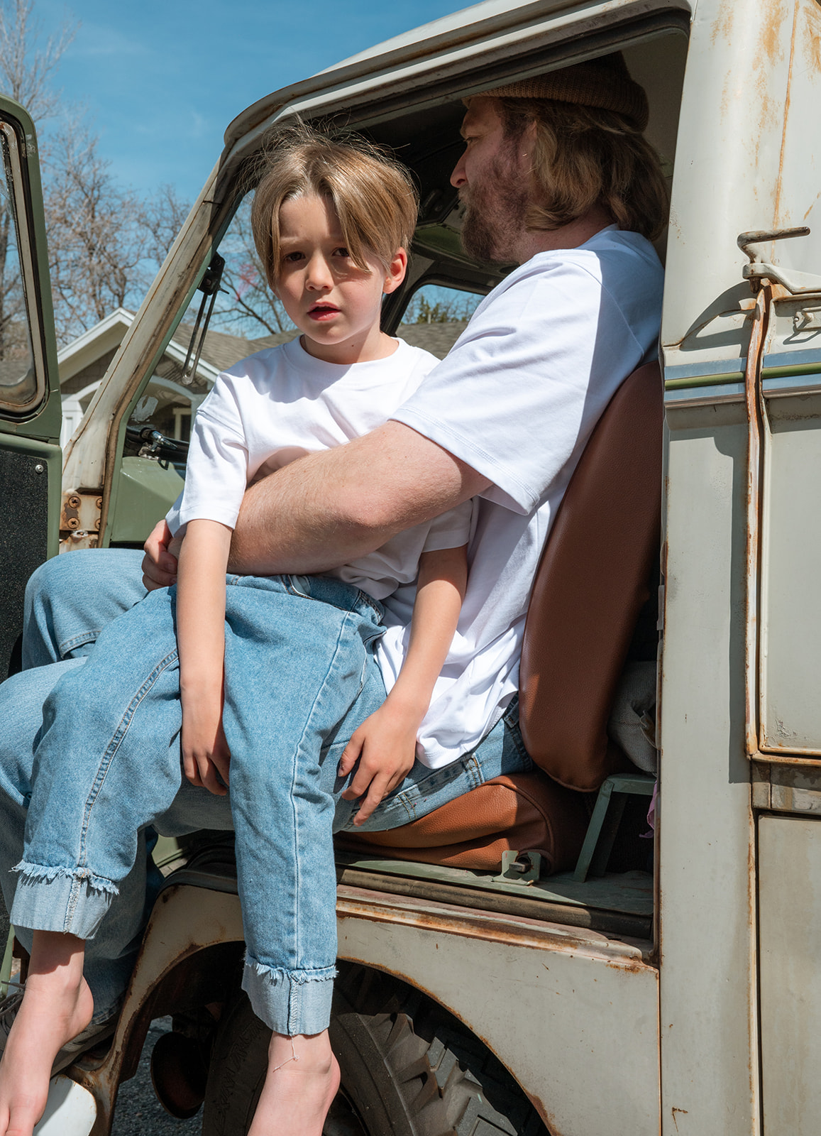 portrait of son and dad in vintage vw truck front seat