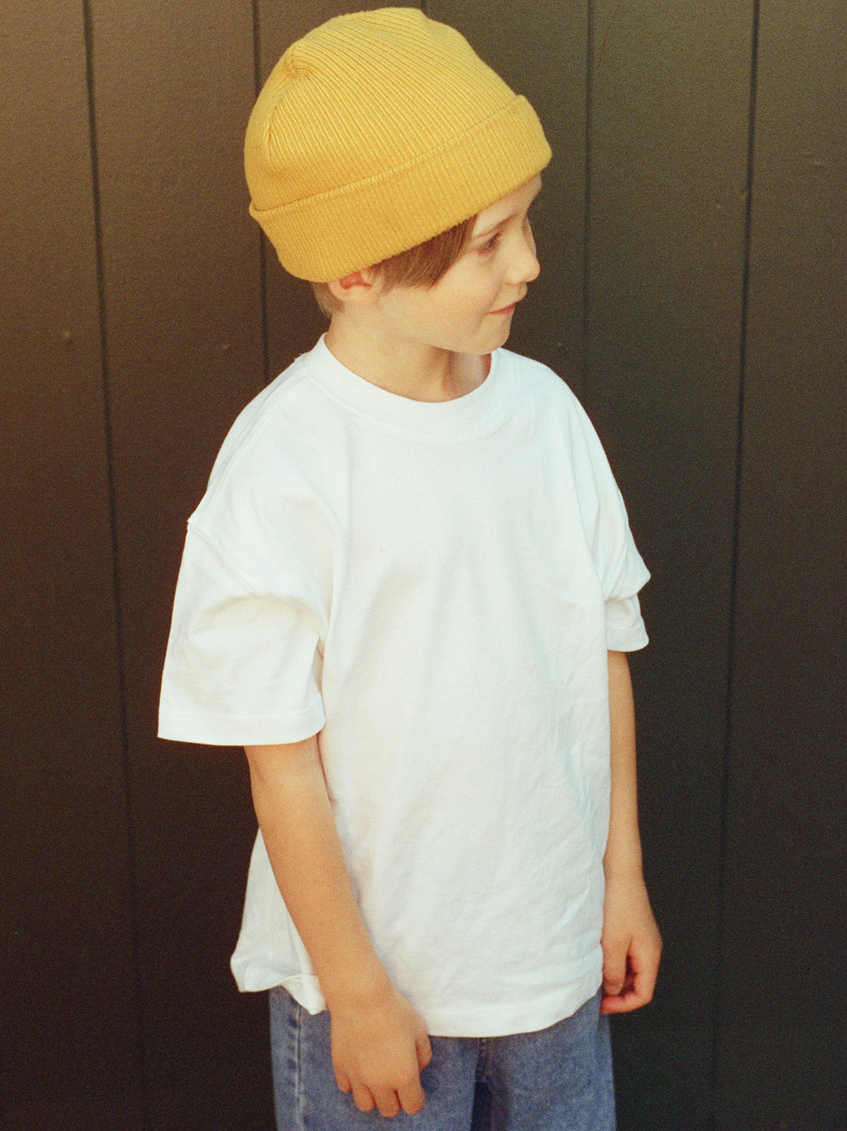 Film portrait of little boy in yellow beanie