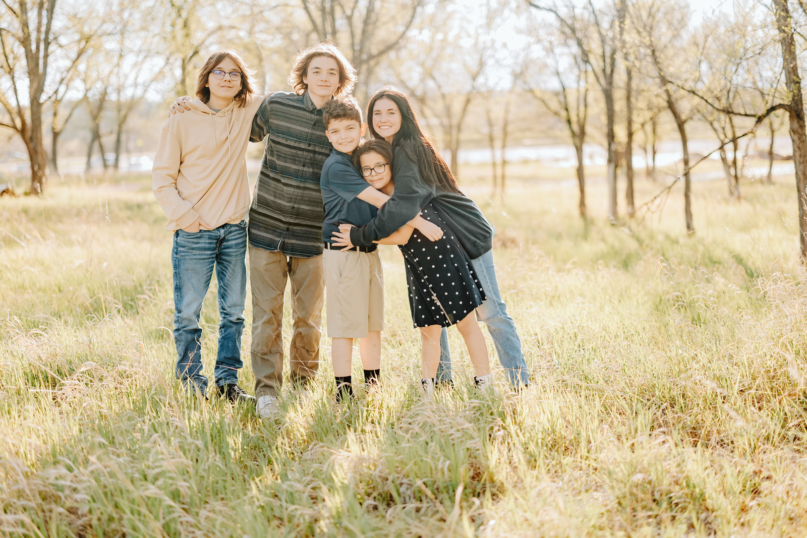 Color portrait of five children in tall grass surrounded by trees in Rapid City, SD