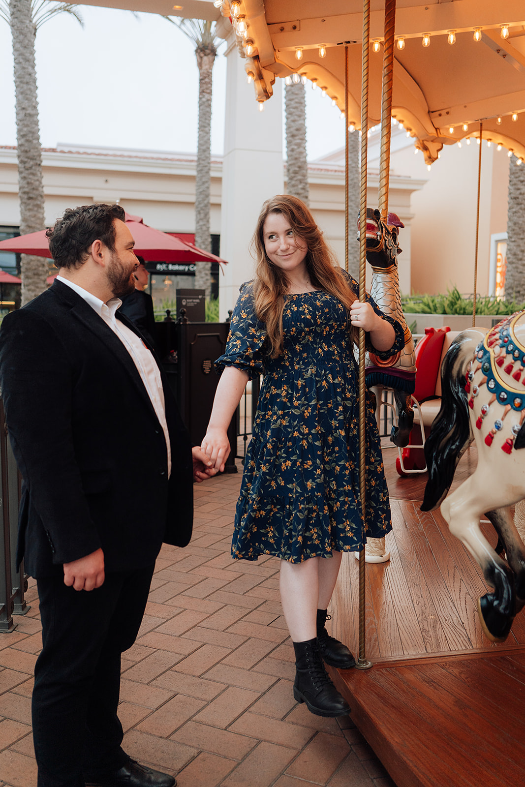 Formal engagement photoshoot couple holding hands Irvine Spectrum Carousel 