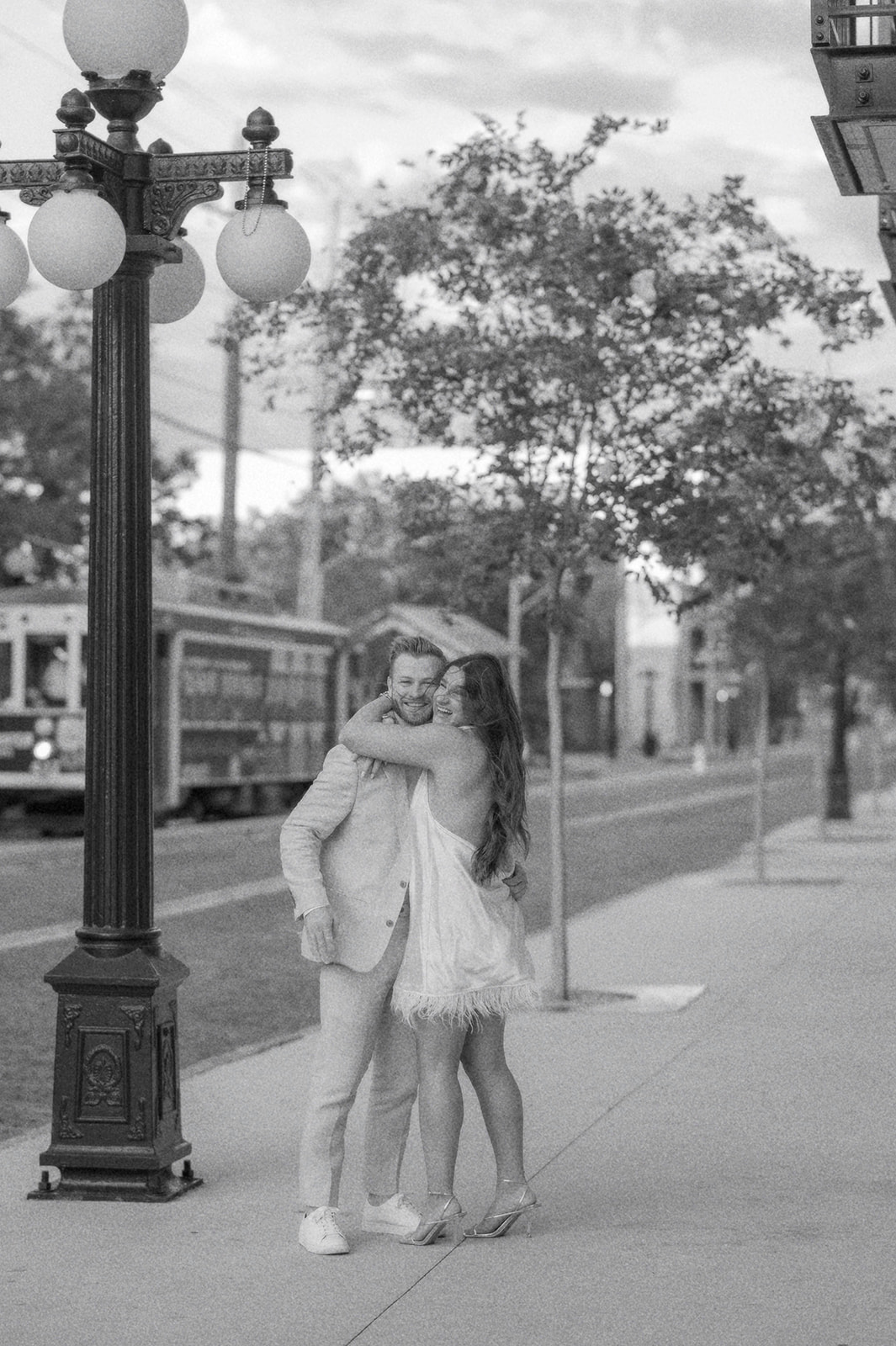 "Couple embracing in Ybor City, Tampa during engagement shoot"

