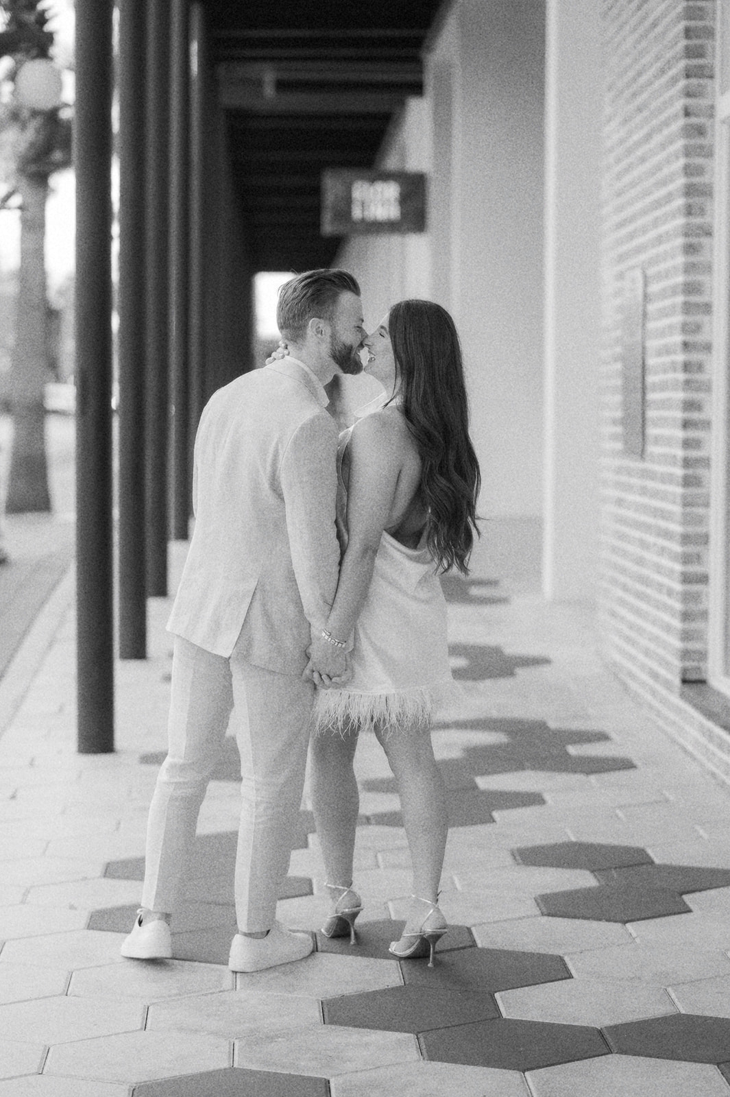 "Couple holding hands on Ybor City street, captured by Tampa photographer"
