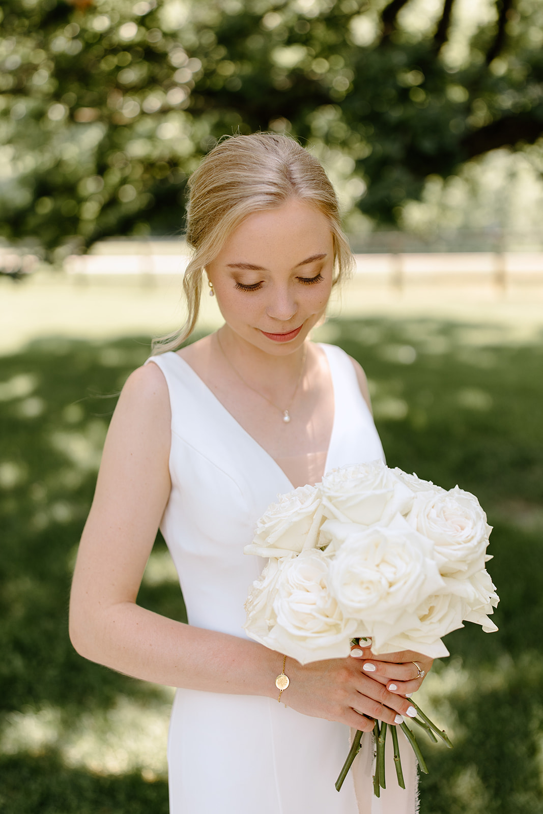Bride smiles holding bouquet