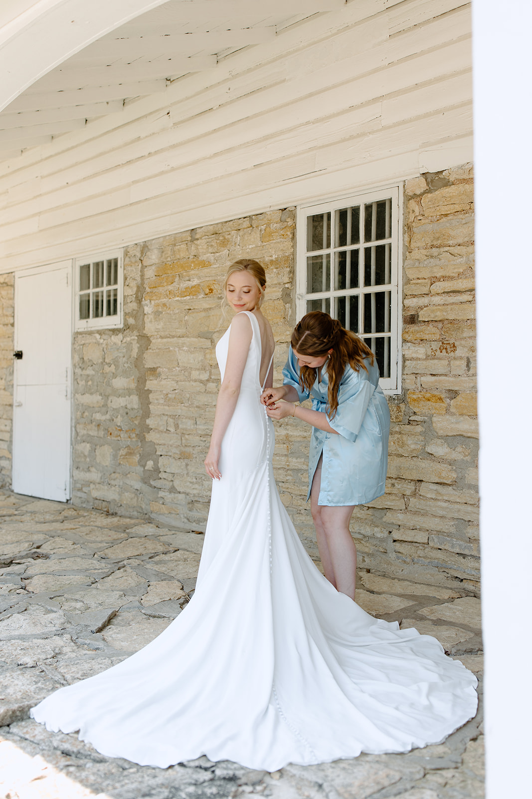 Bride gets into her dress 
