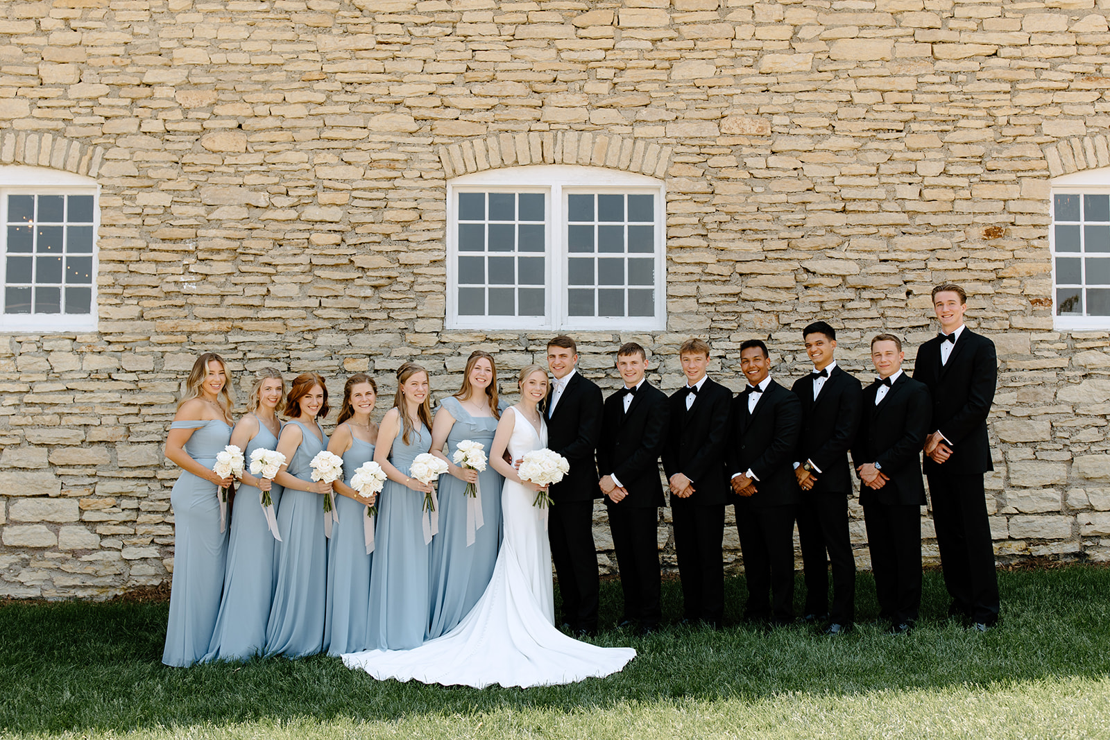 Wedding party in front of brick building