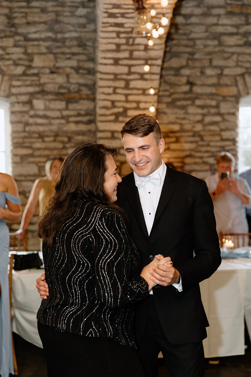 Groom and his mom dancing