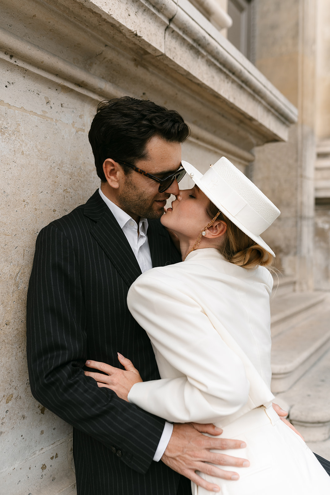 Sophisticated elegant french couple kissing at the louvre in Paris