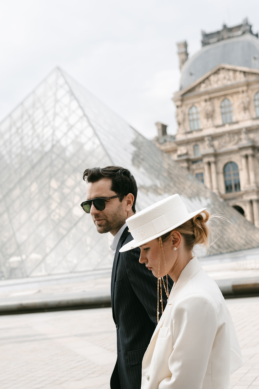 Sophisticated elegant french couple walking at the louvre in Paris