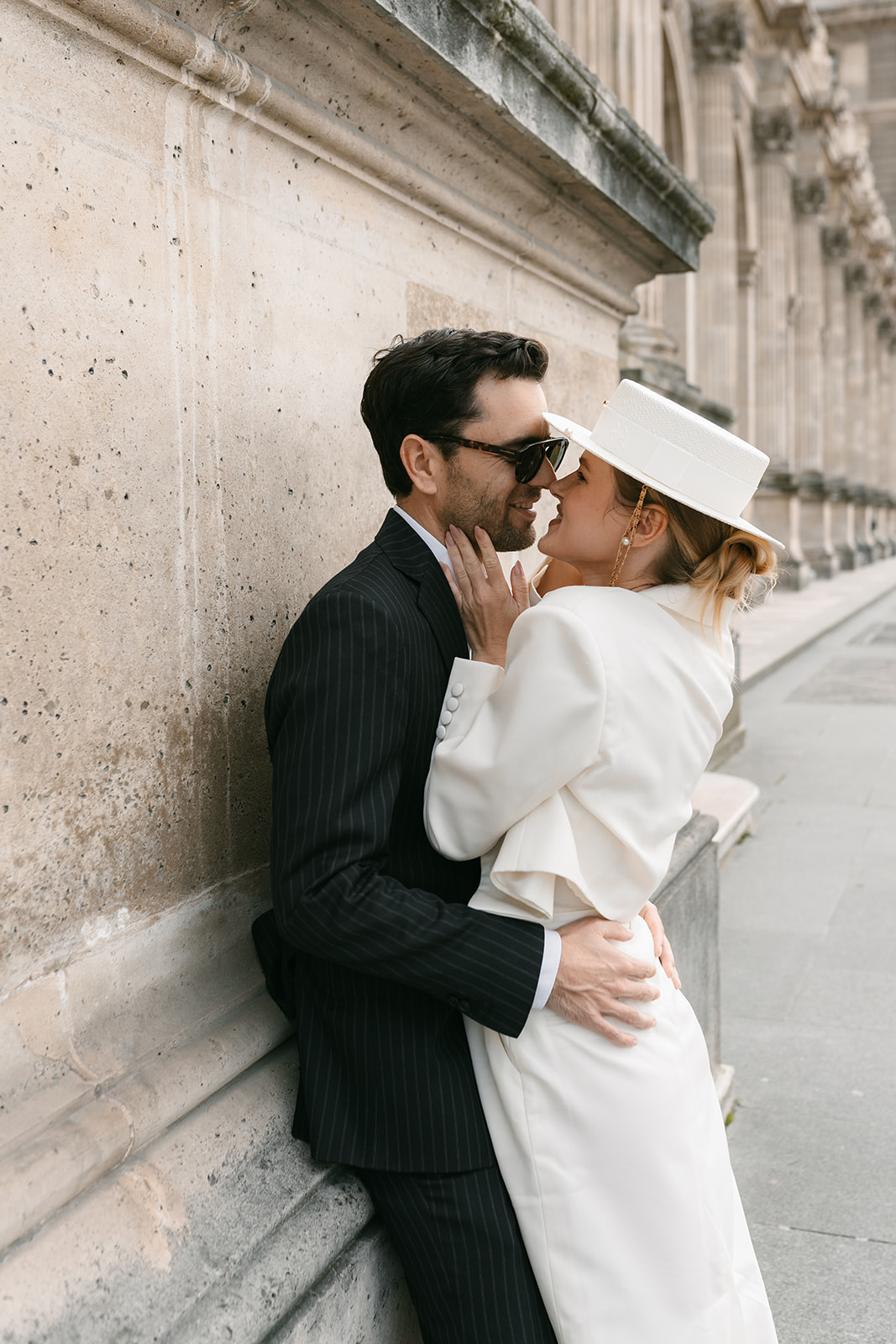 Sophisticated elegant french couple embracing each other at the Louvre in Paris