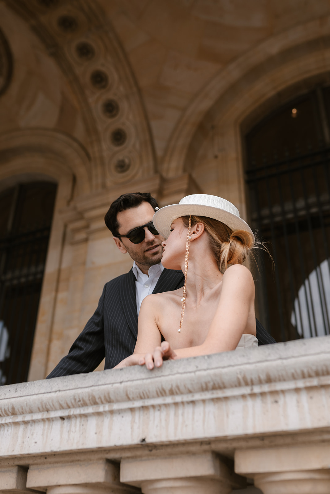Sophisticated elegant french couple posing at the louvre in Paris