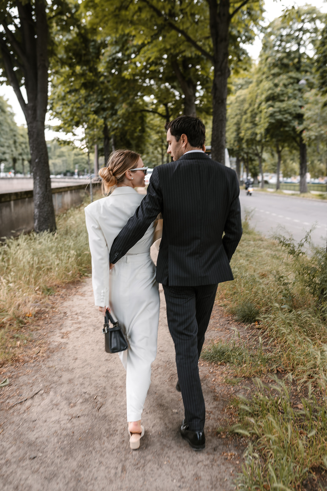 Sophisticated elegant french couple walking in Paris