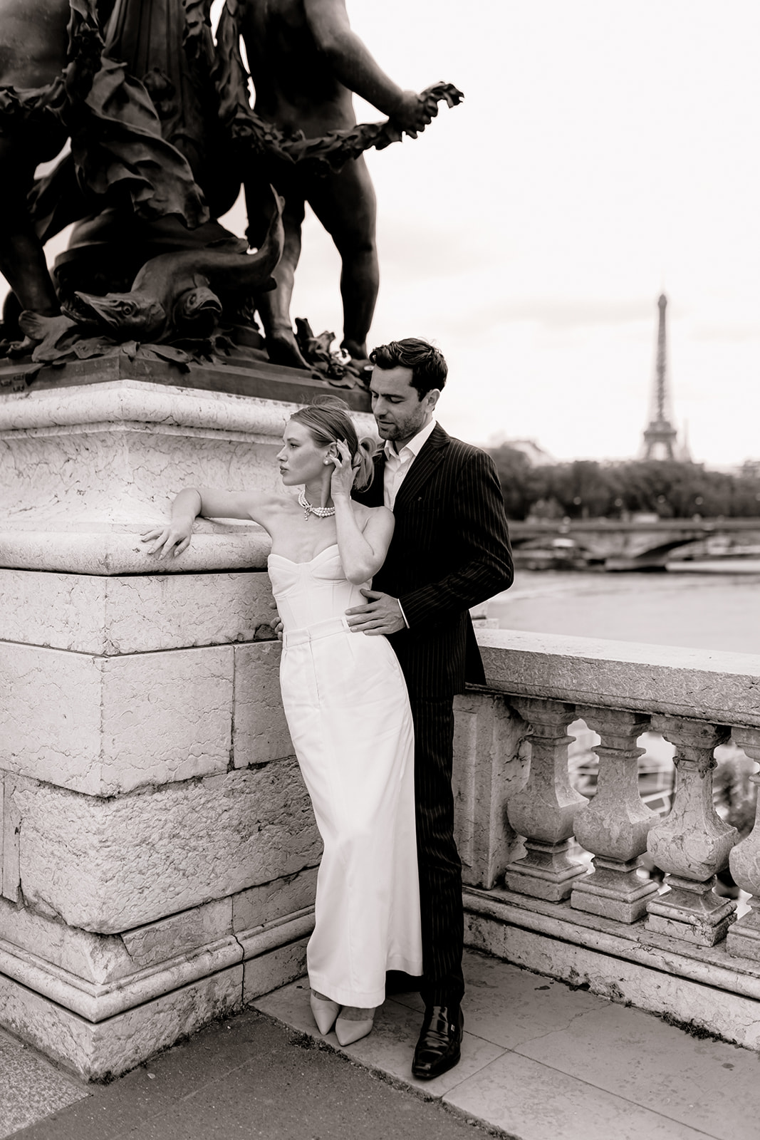 Sophisticated elegant french couple in front of the Tour Eiffel on pont alexandre III
