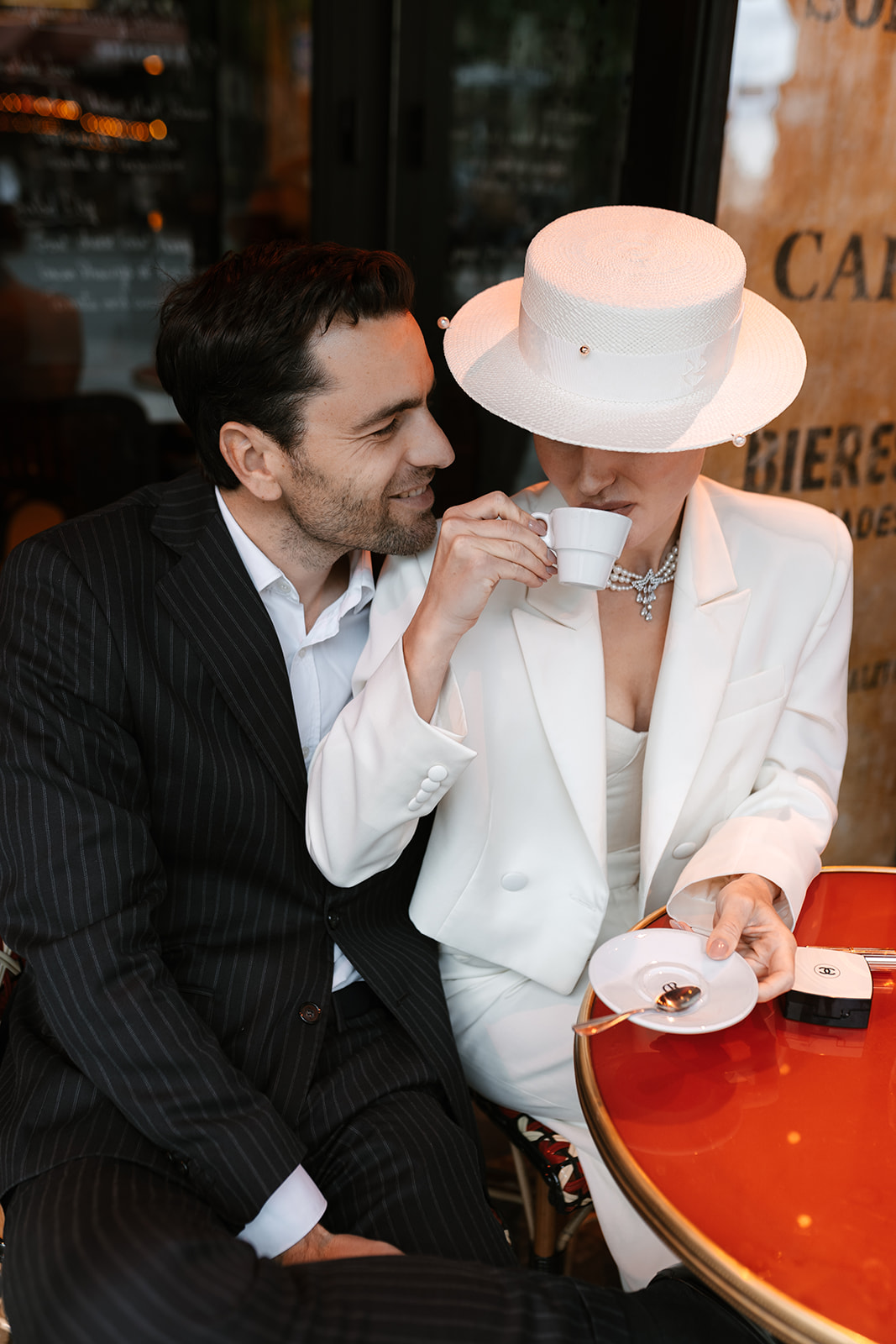 Sophisticated elegant french couple having coffee in a french bistrot