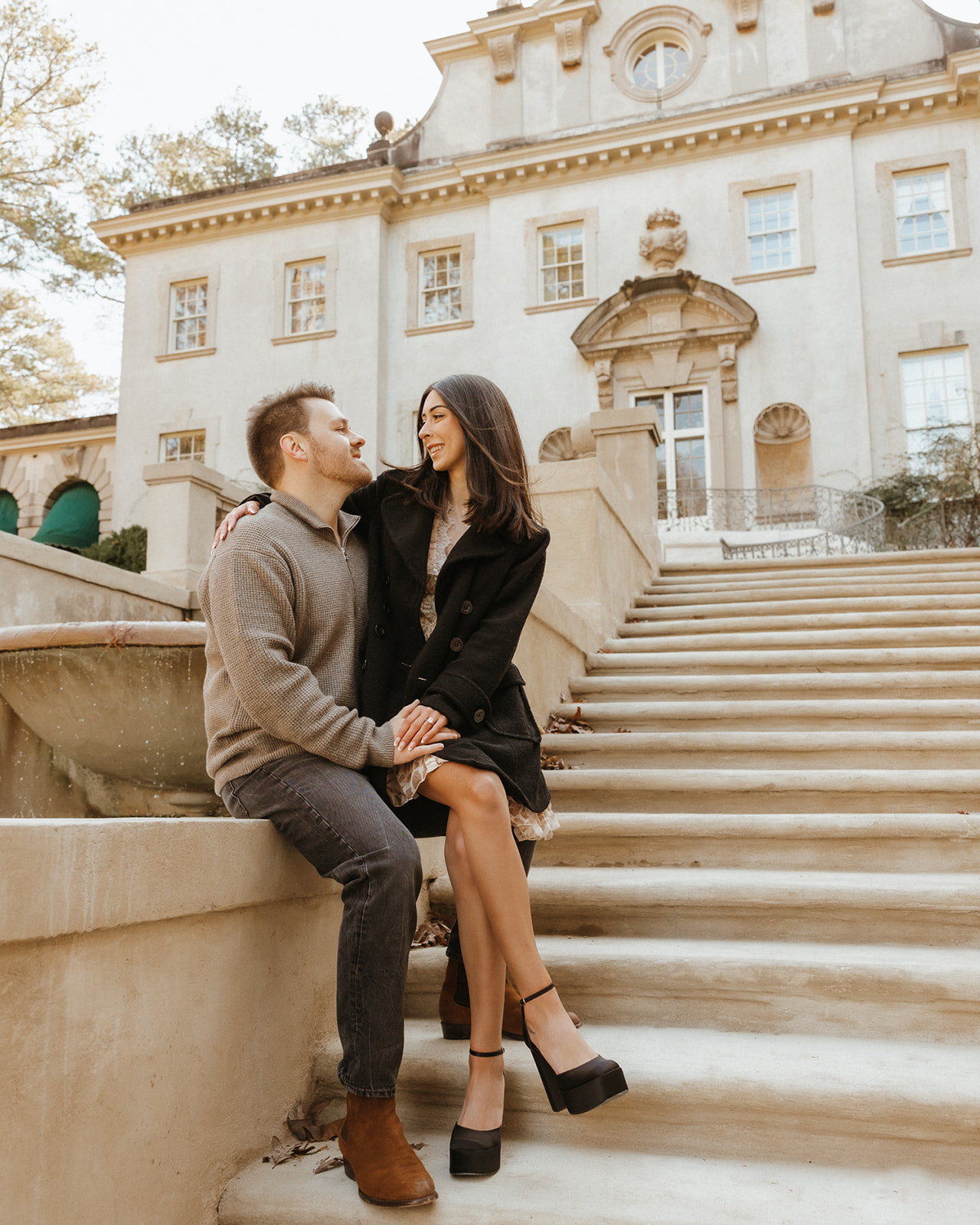 Engaged couple at the steps of the Swan House at Atlanta History Center
